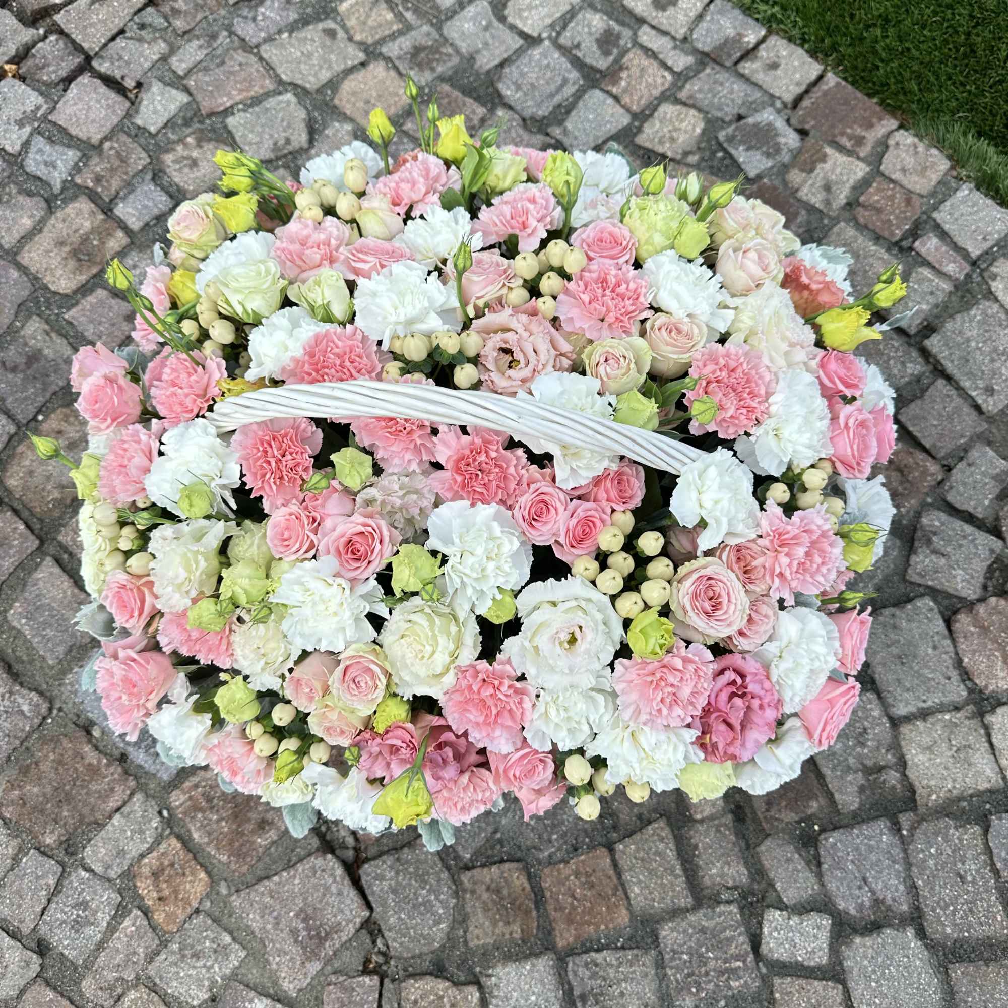 Large basket of pink and white flowers with a white handle