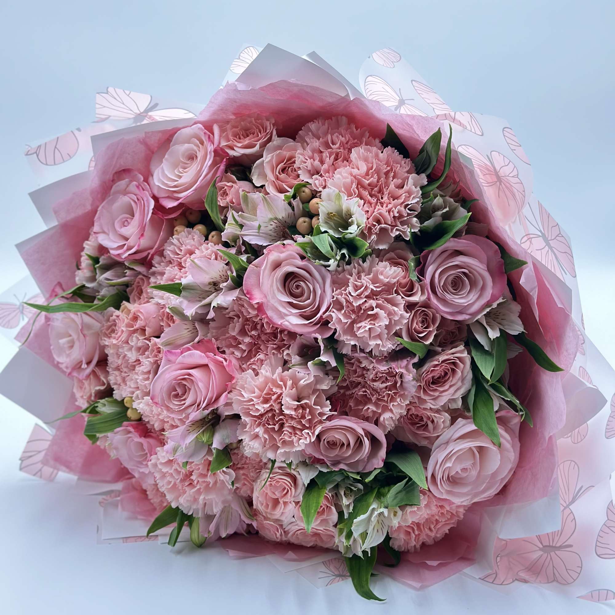Pink rose and carnation bouquet wrapped in pink paper