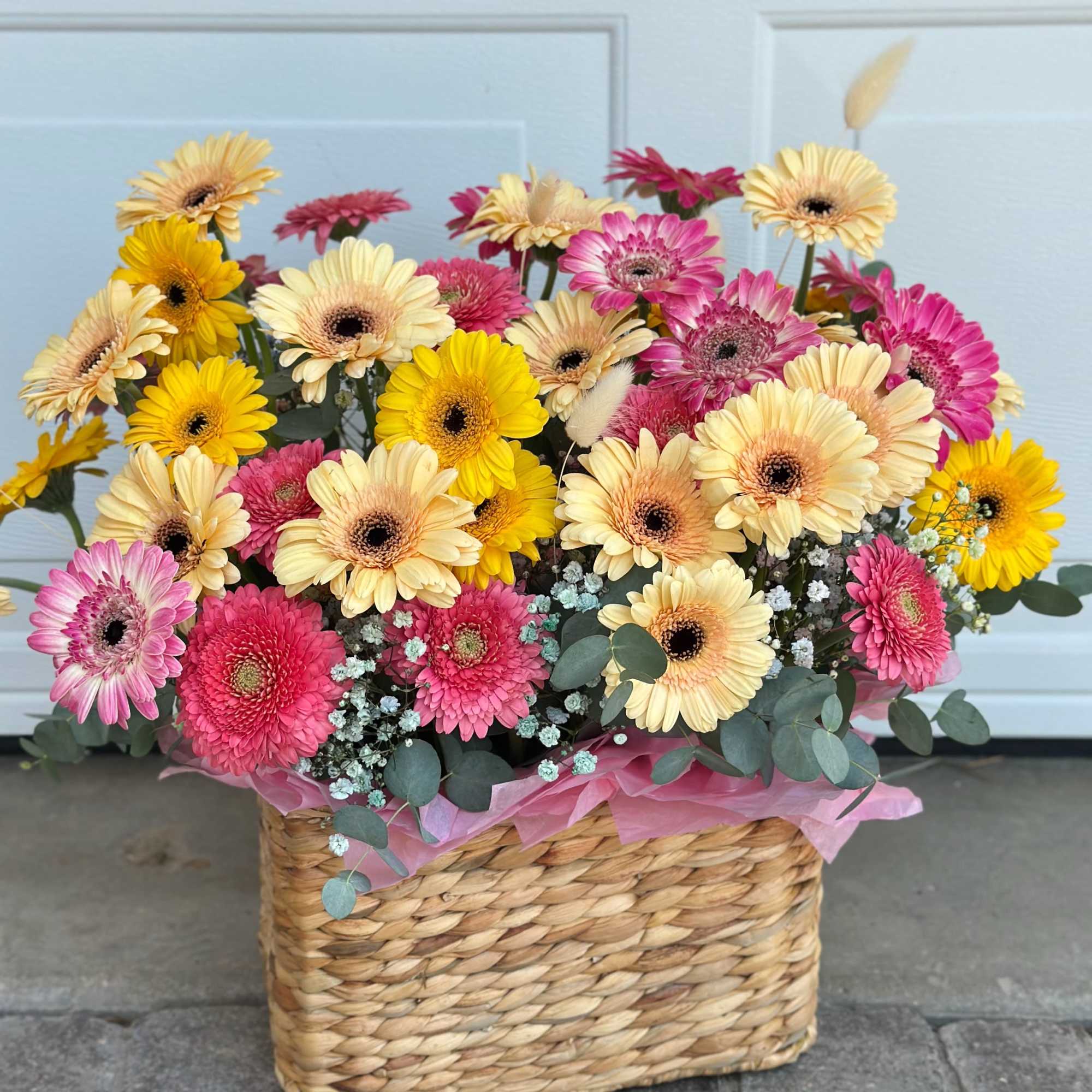 Mixed gerbera daisy bouquet in a woven basket