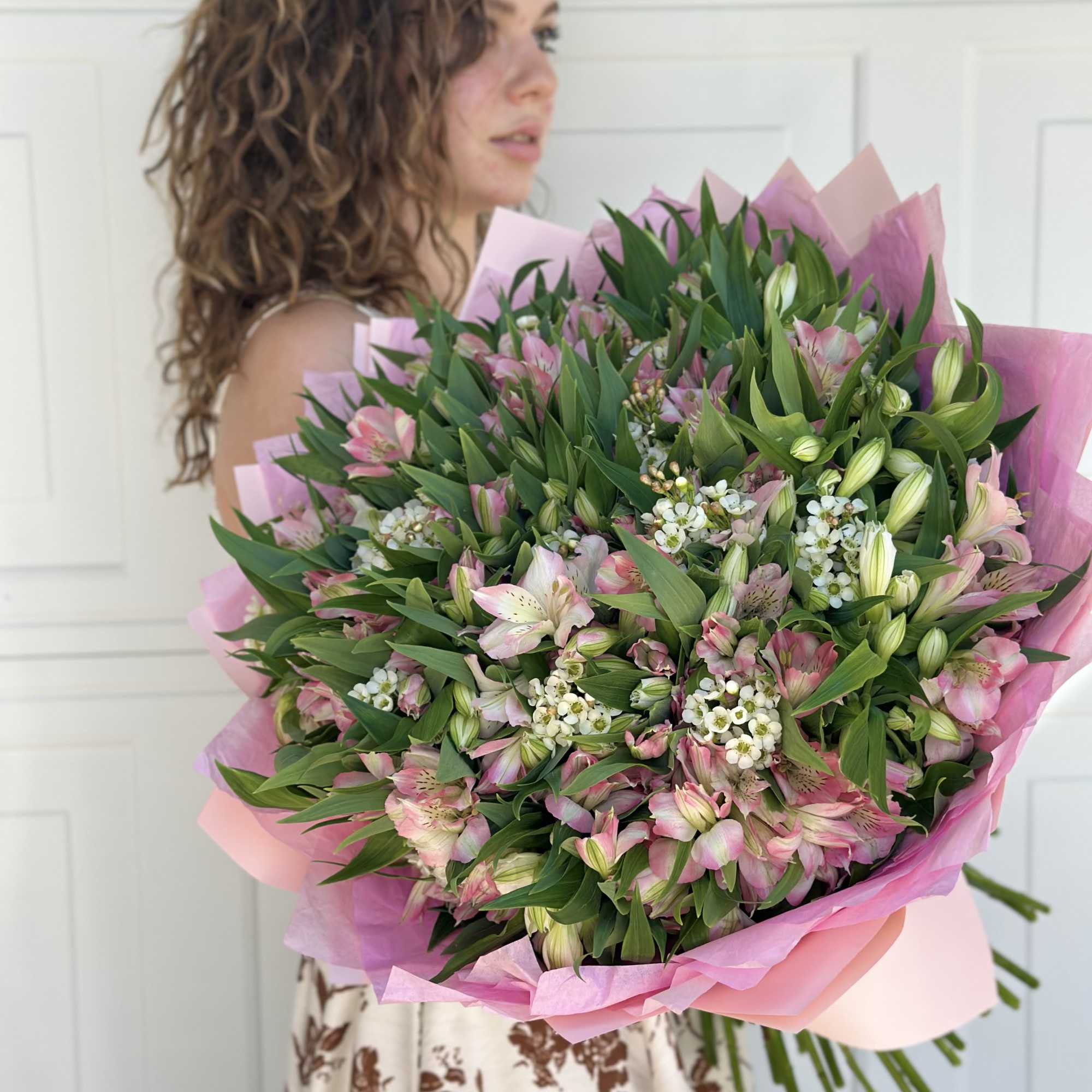 Large pink and white bouquet with lilies and alstroemeria wrapped in pink paper