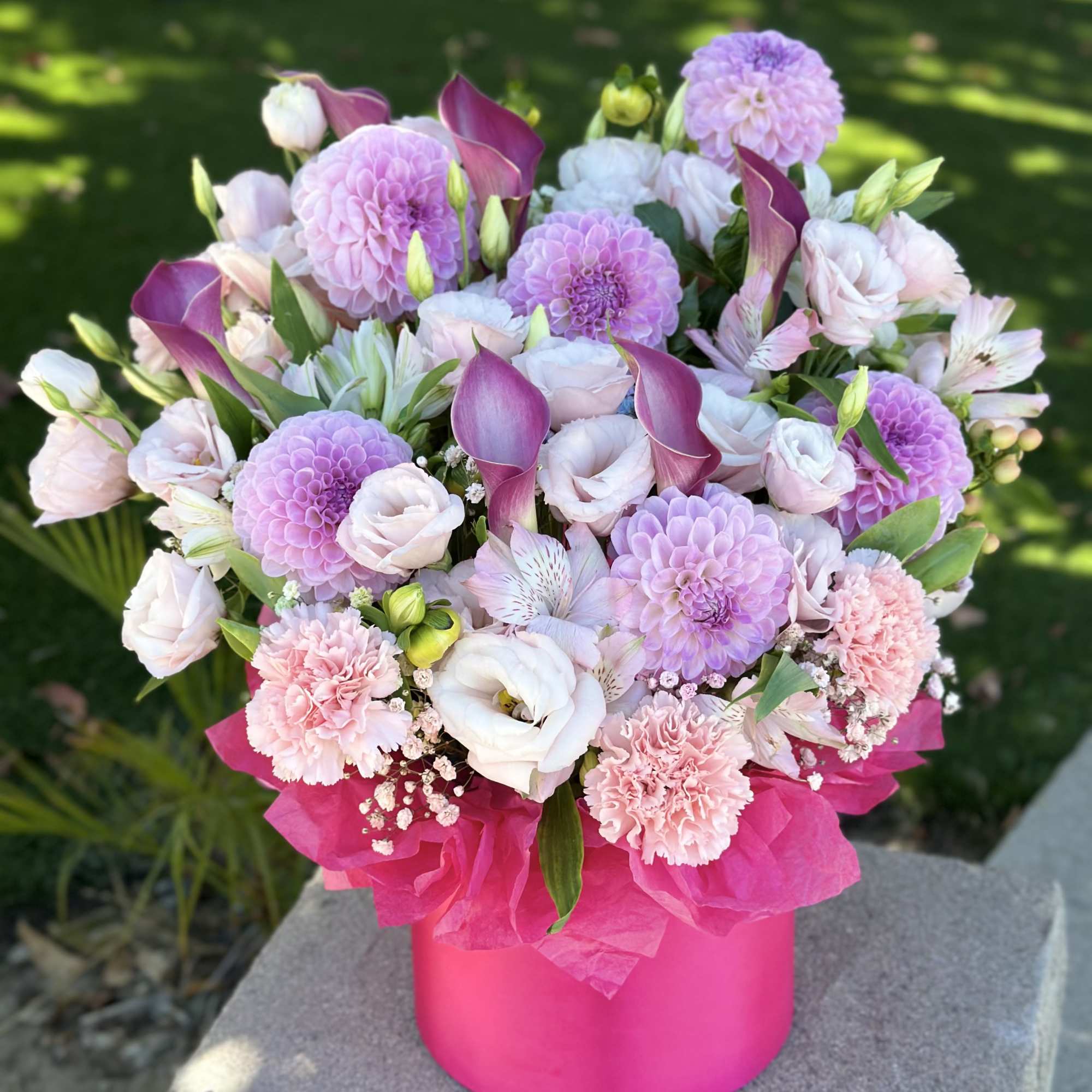 Pink and lavender bouquet in a bright pink box