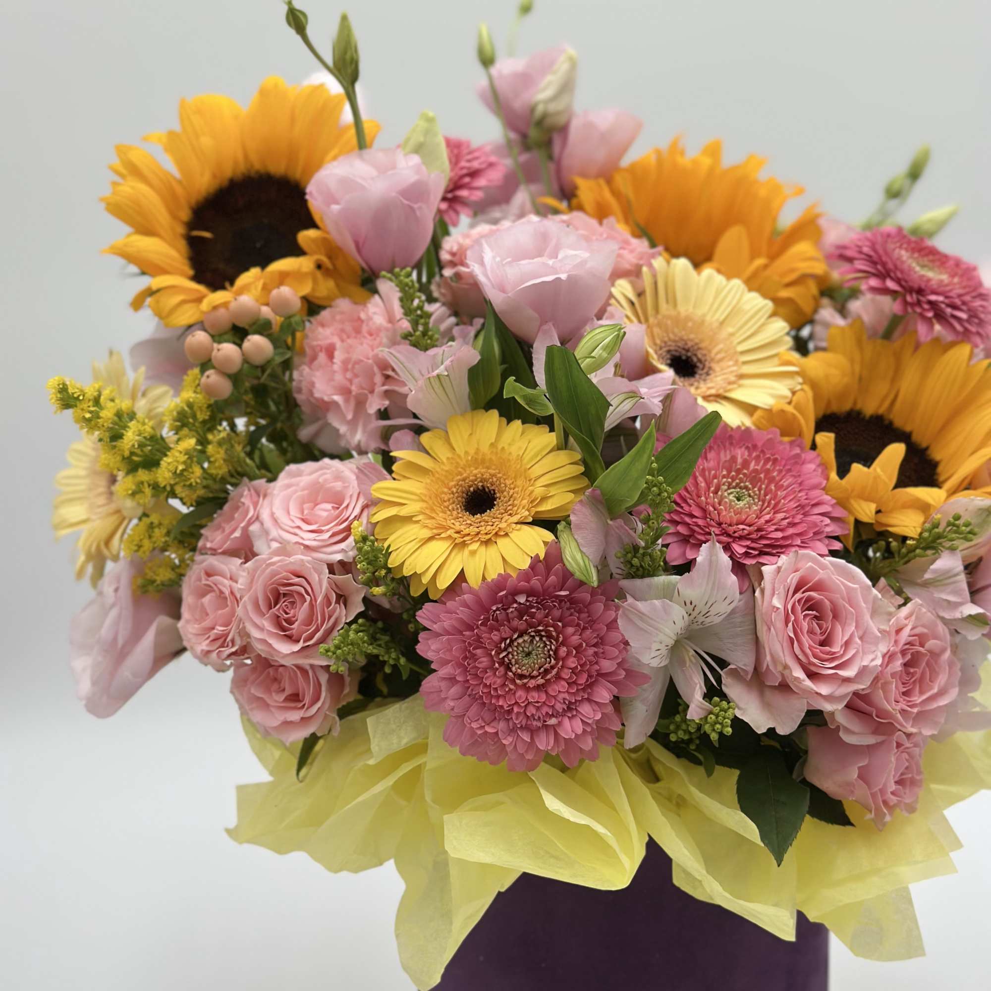 Mixed bouquet with sunflowers, pink roses, and gerbera daisies in a purple vase, photo 3 of 4