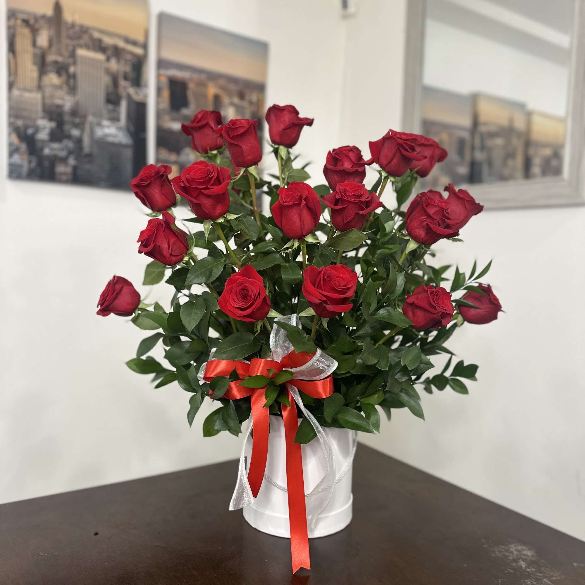 Bouquet of red roses in a white box tied with red and silver ribbon