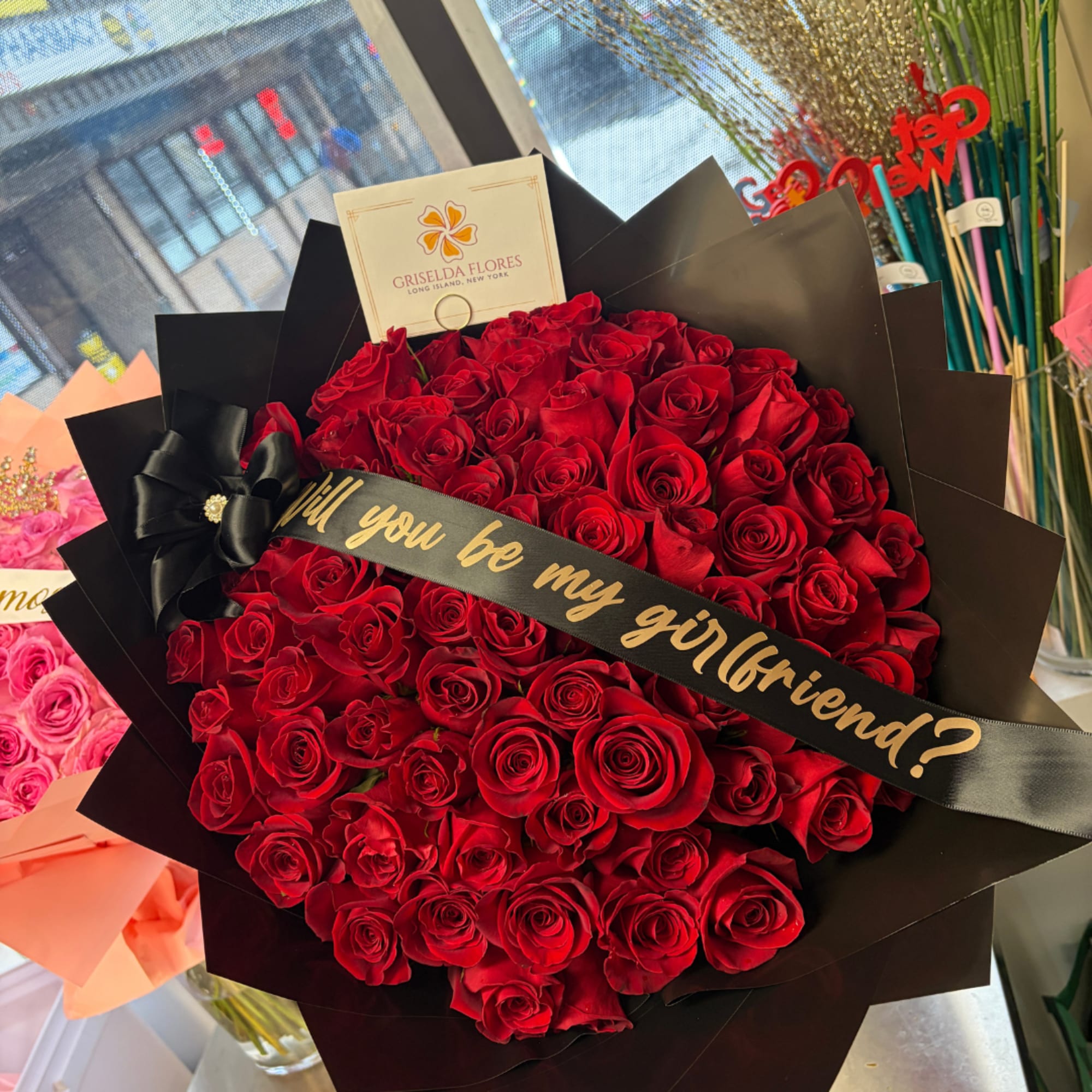 Large bouquet of red roses wrapped in black paper with a ribbon, photo 4 of 4