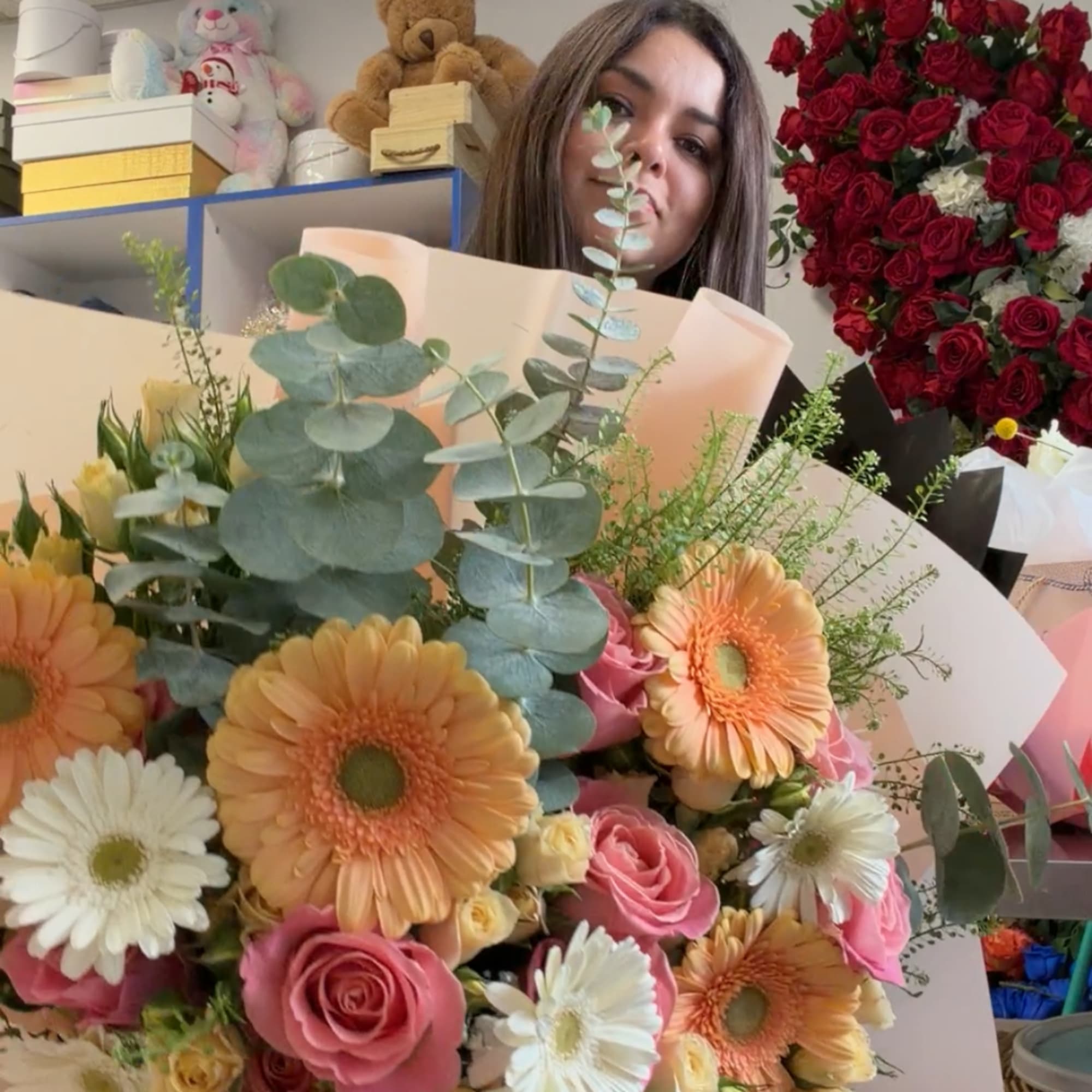 Large bouquet of pink roses, peach gerbera daisies, and white daisies