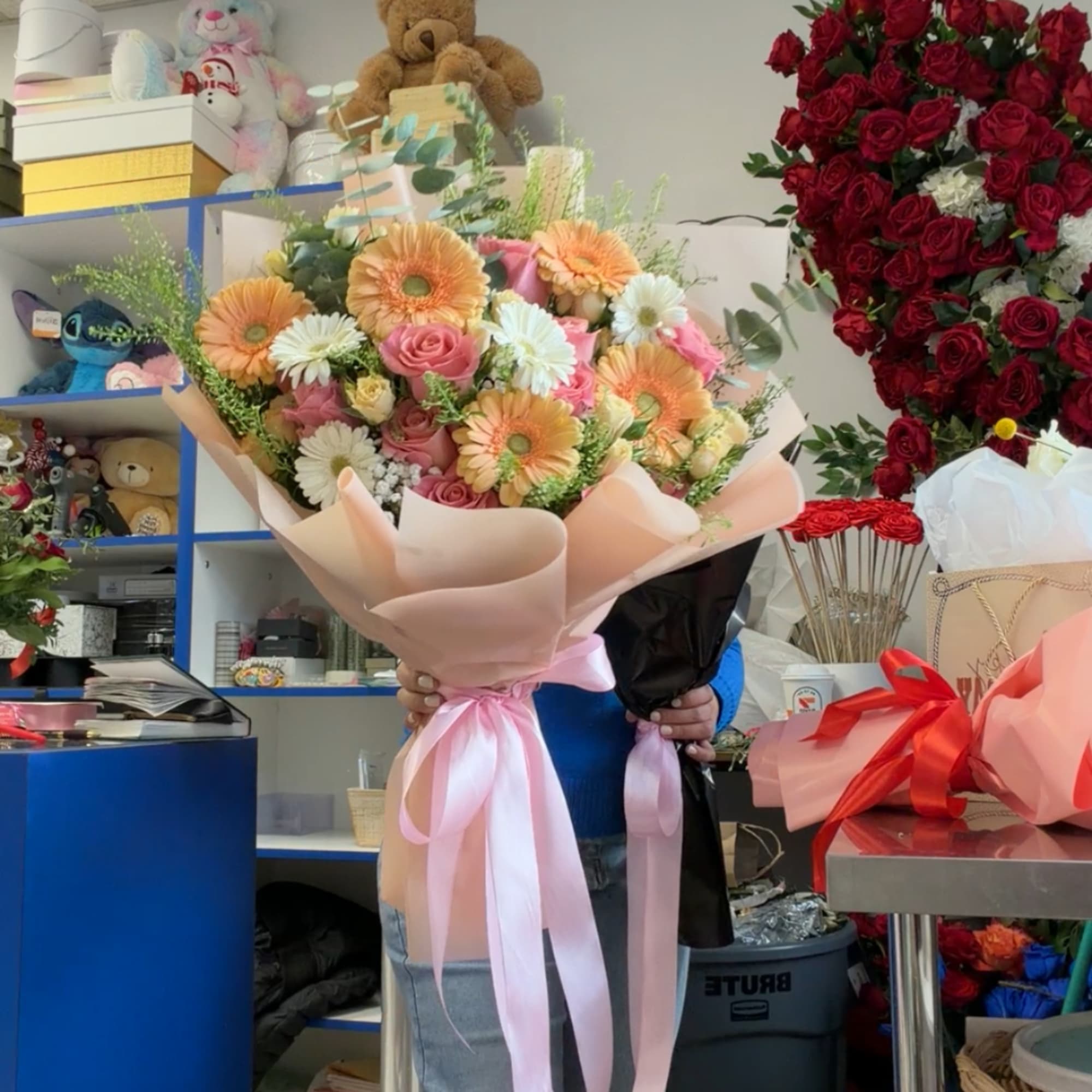 Large bouquet of pink roses and peach gerbera daisies wrapped in blush paper, photo 4 of 5