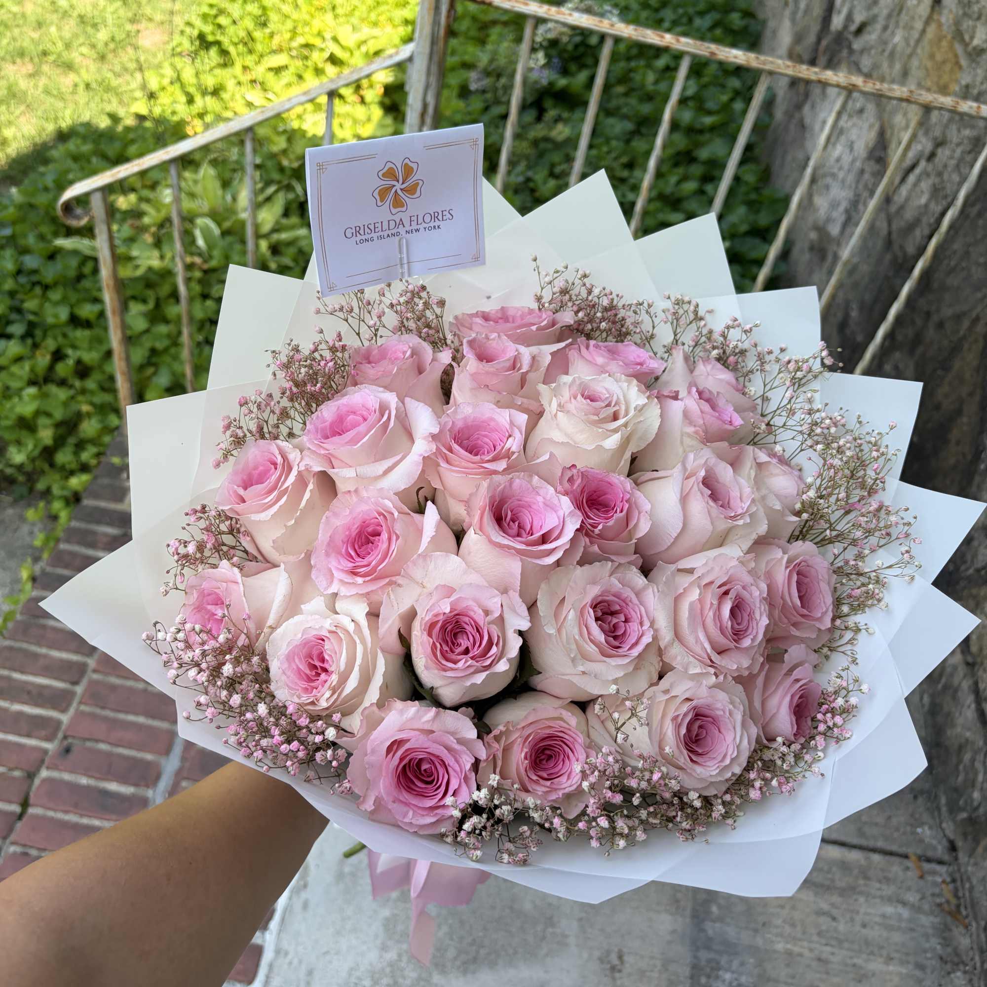 Bouquet of pink roses wrapped in white paper