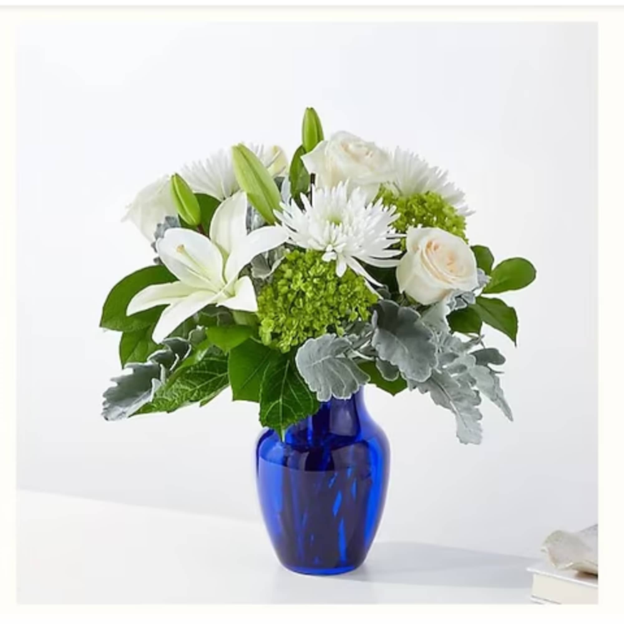 White flowers arranged in a blue glass vase