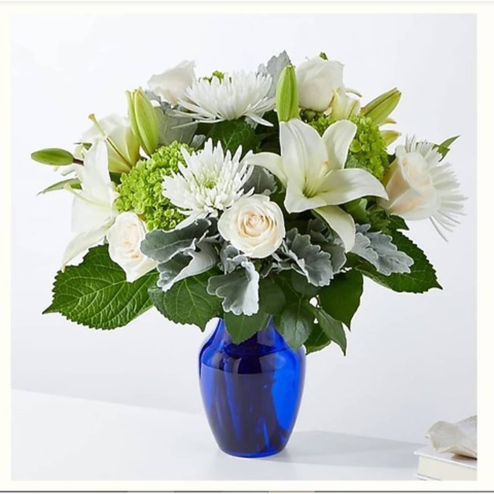White flowers arranged in a blue glass vase