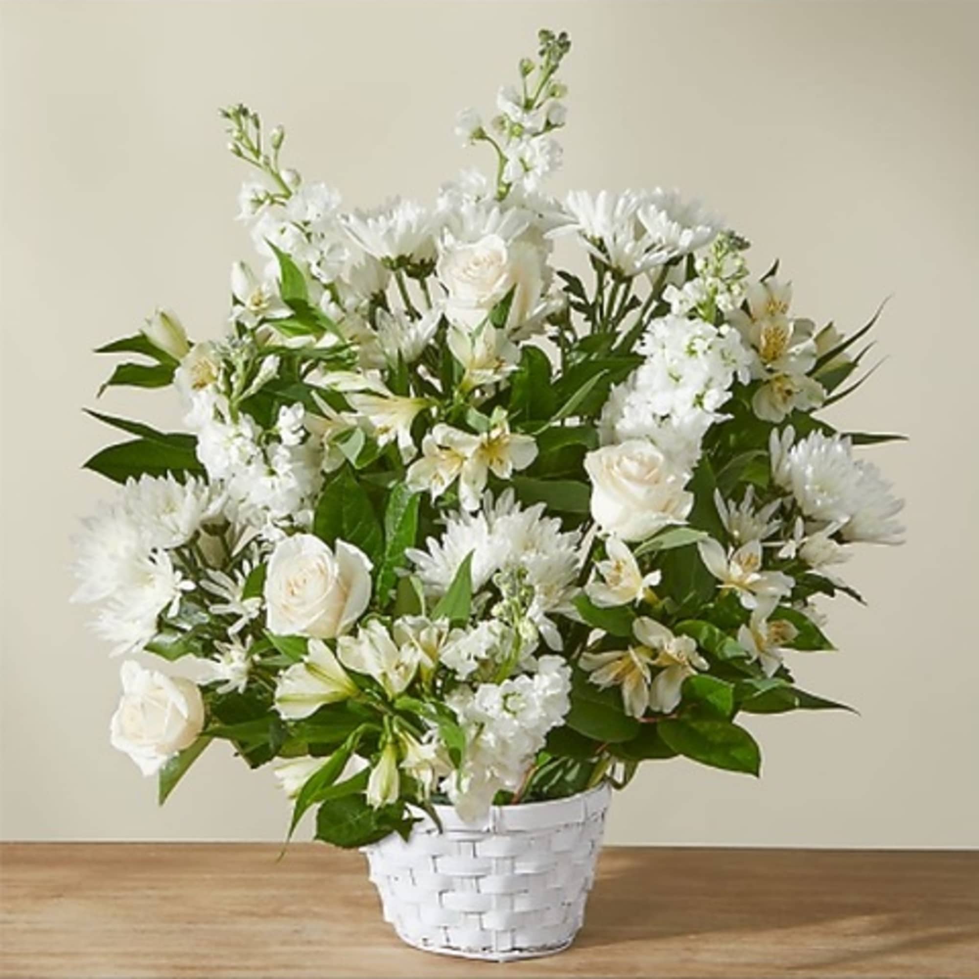 White flowers arranged in a white basket vase