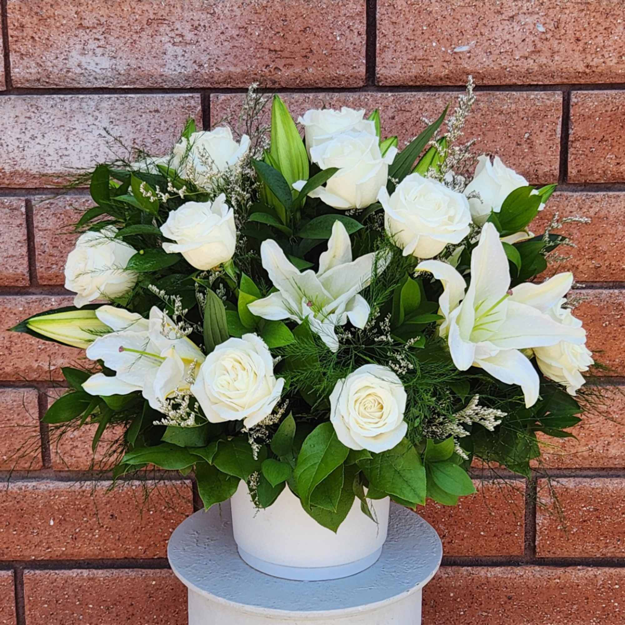 White roses and lilies arranged in a white vase, photo 2 of 2
