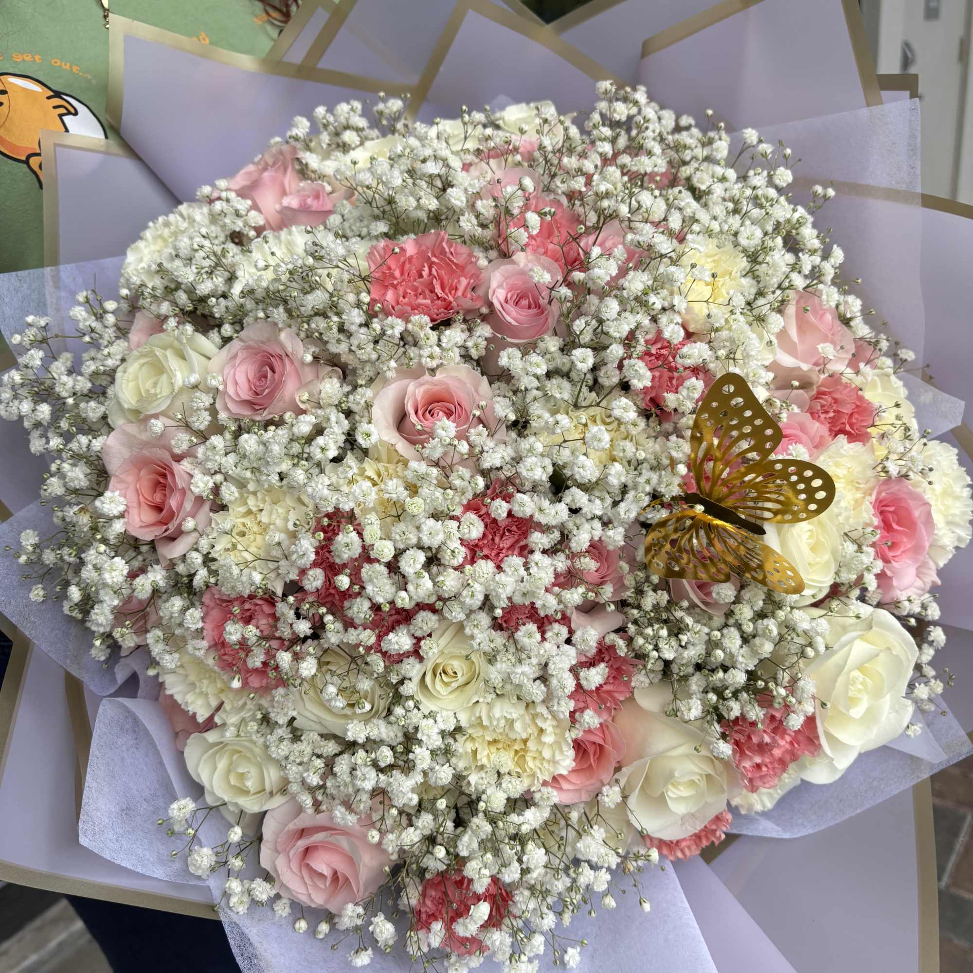 Large bouquet of pink and white roses with baby's breath in lavender wrap