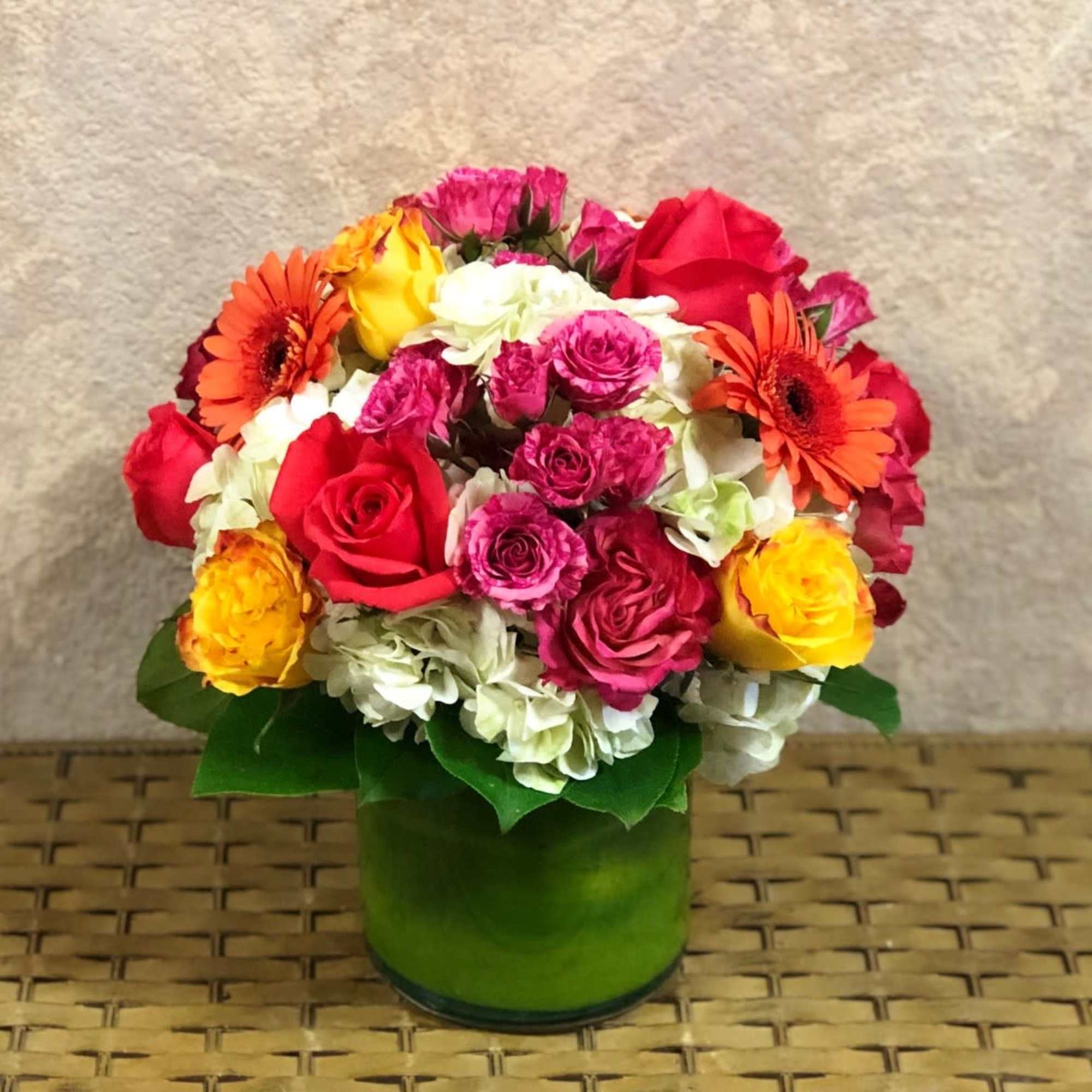 Mixed bouquet of roses, gerbera daisies, and hydrangeas in a green vase, photo 2 of 2