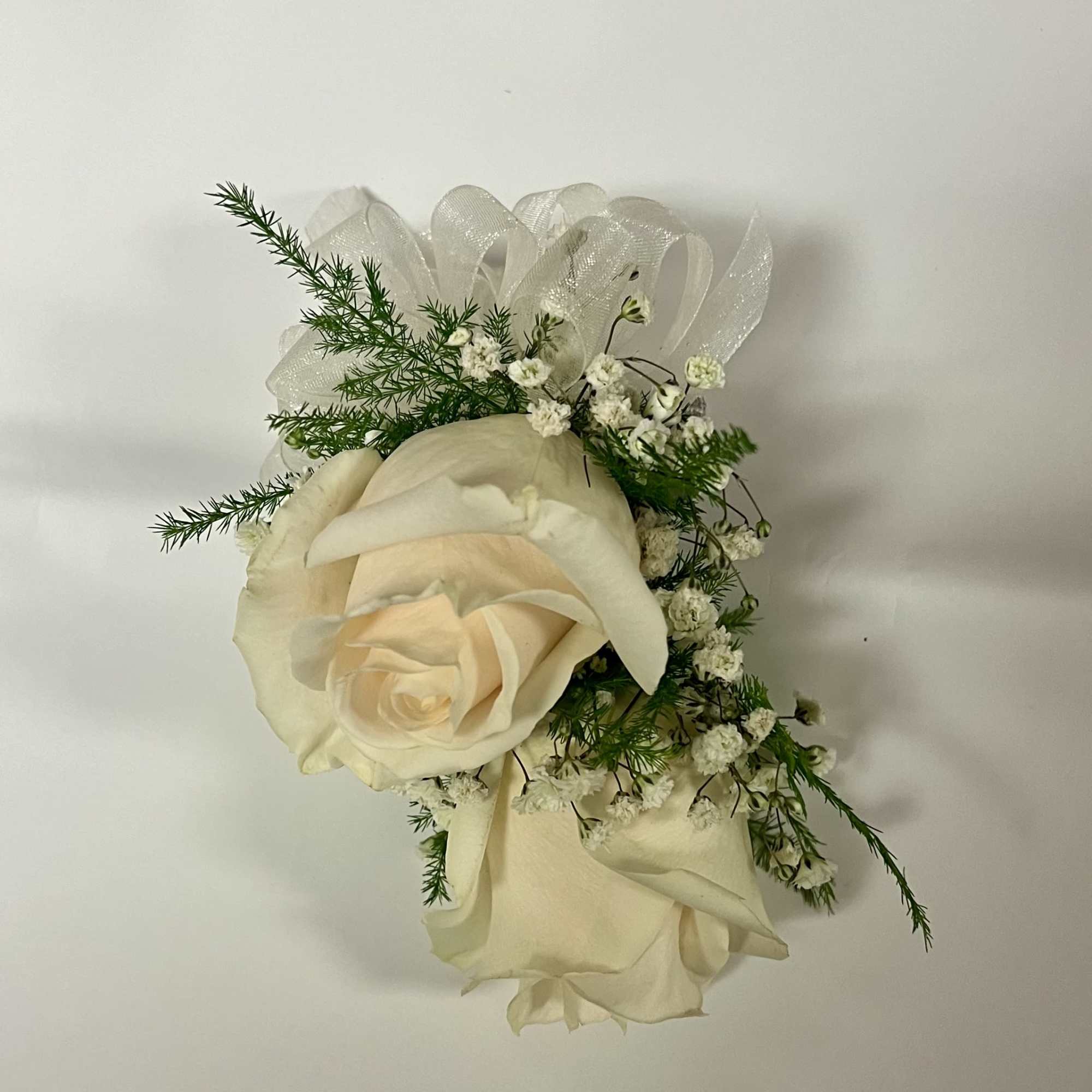 Small ivory rose corsage with white ribbon and baby’s breath