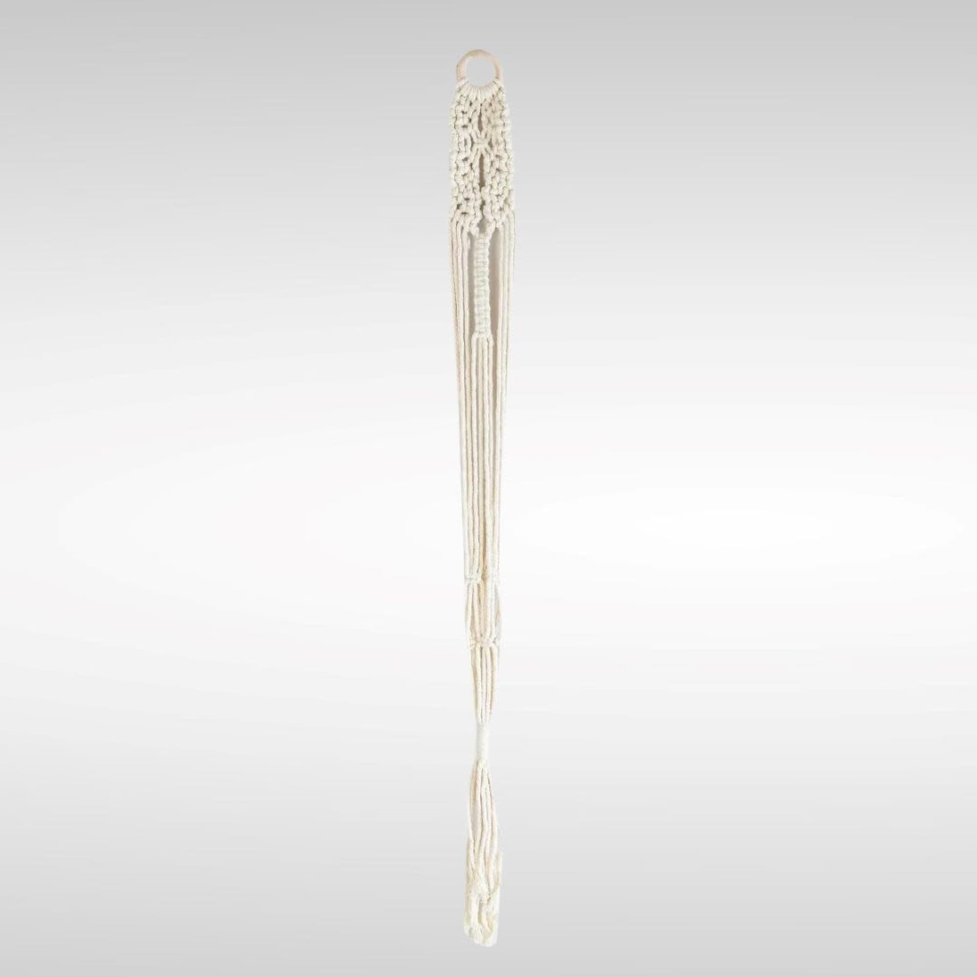 Cream macramé wall hanging with a ring top and long tassels