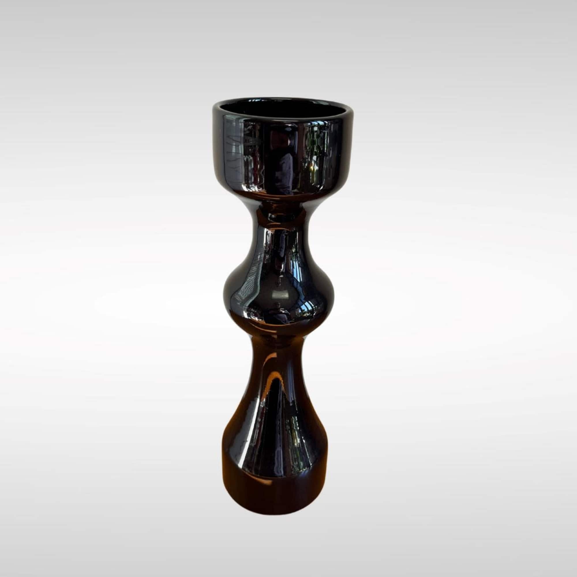 Black glossy decorative candle holder on a white background