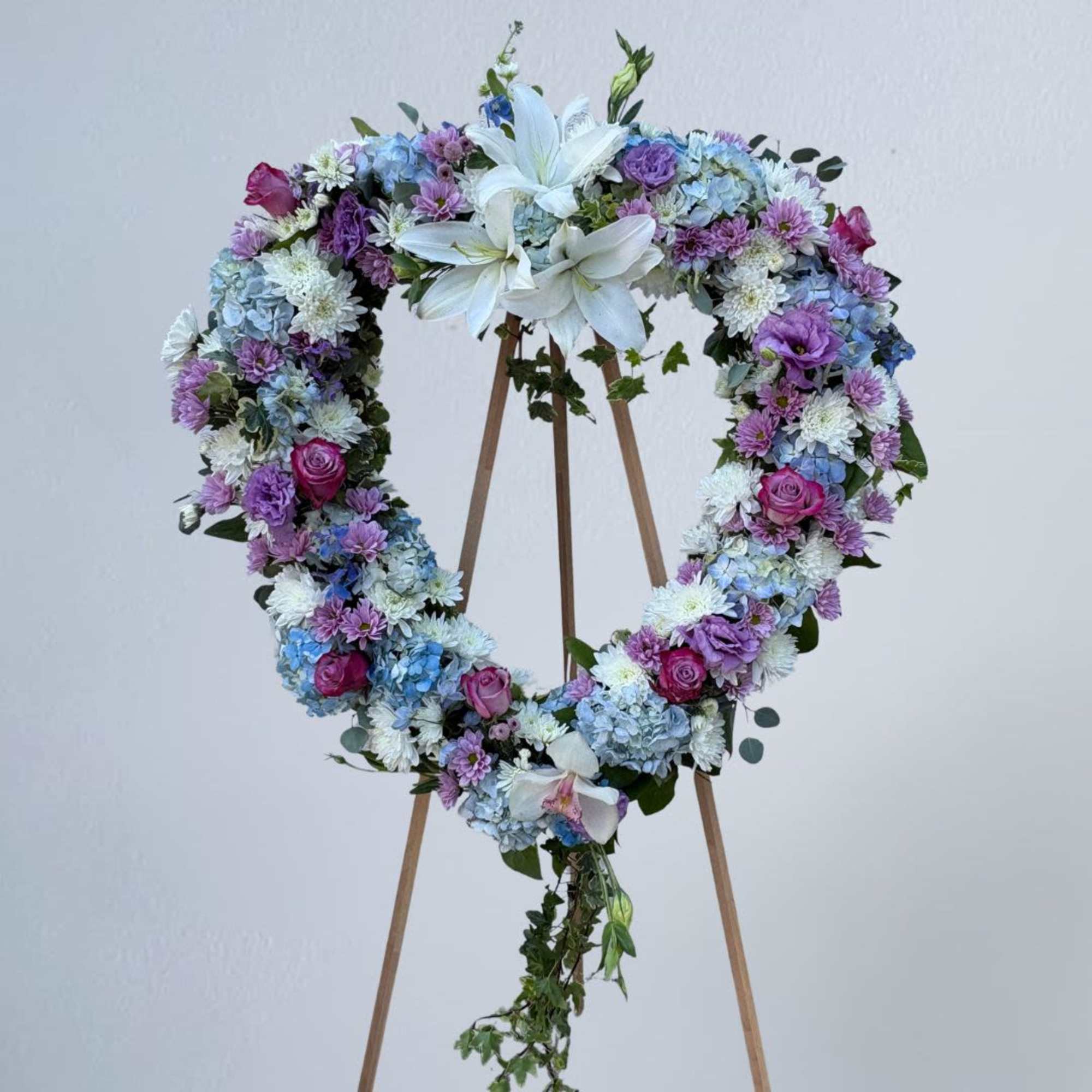 Our Blue and Lavender Heart-Shaped Sympathy Wreath Easle includes white casablanca lilies, photo 2 of 2