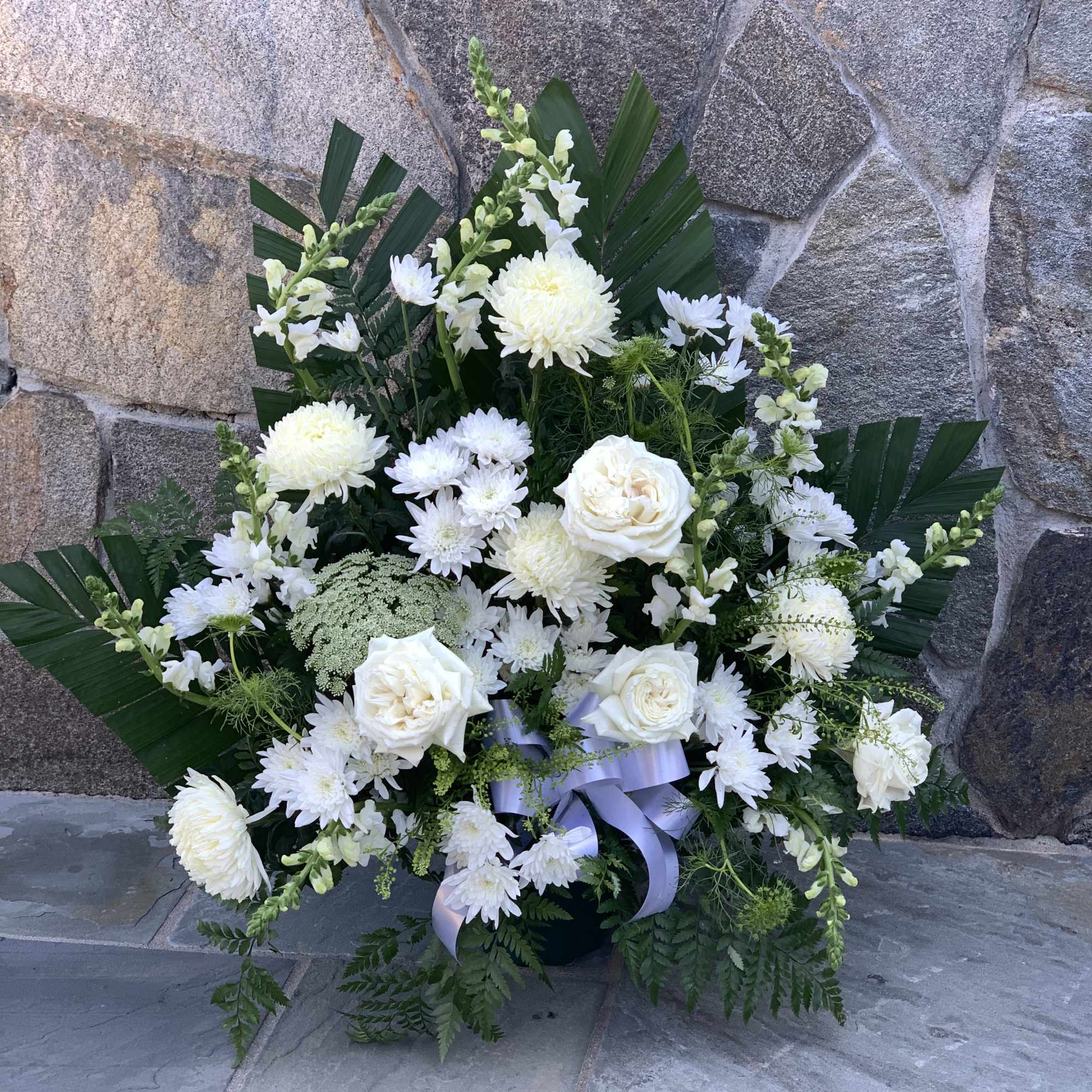 White floral arrangement with roses and chrysanthemums in a vase