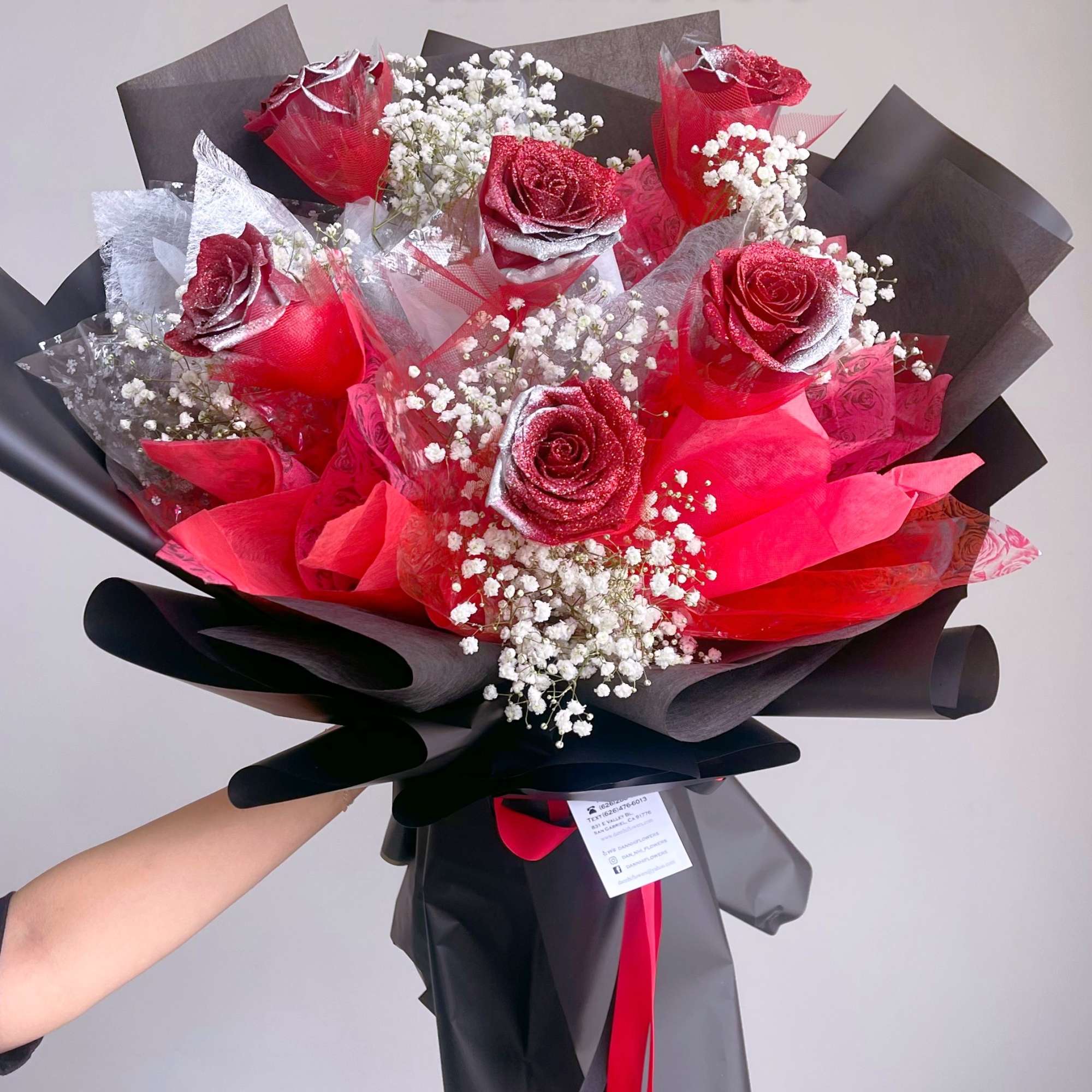Bouquet of red glitter roses with baby's breath in black and red wrap