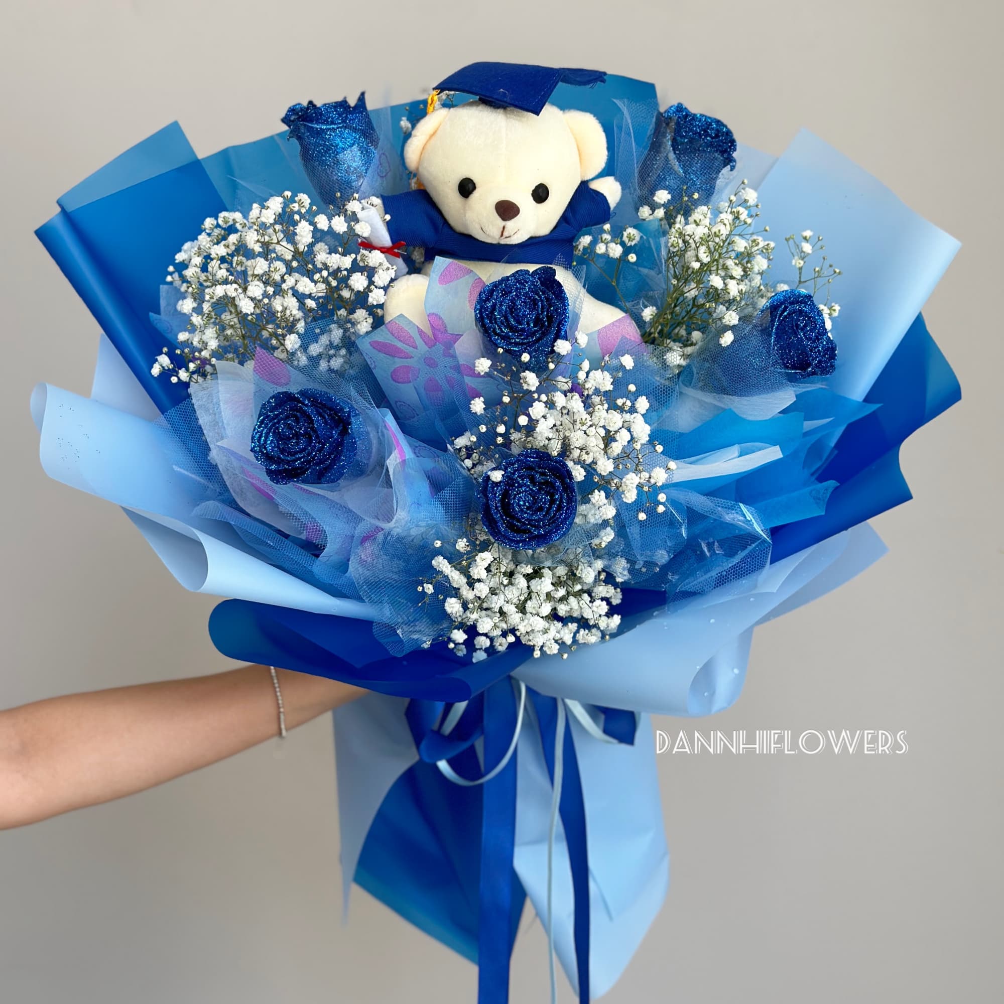 Blue bouquet with a teddy bear and glittery roses