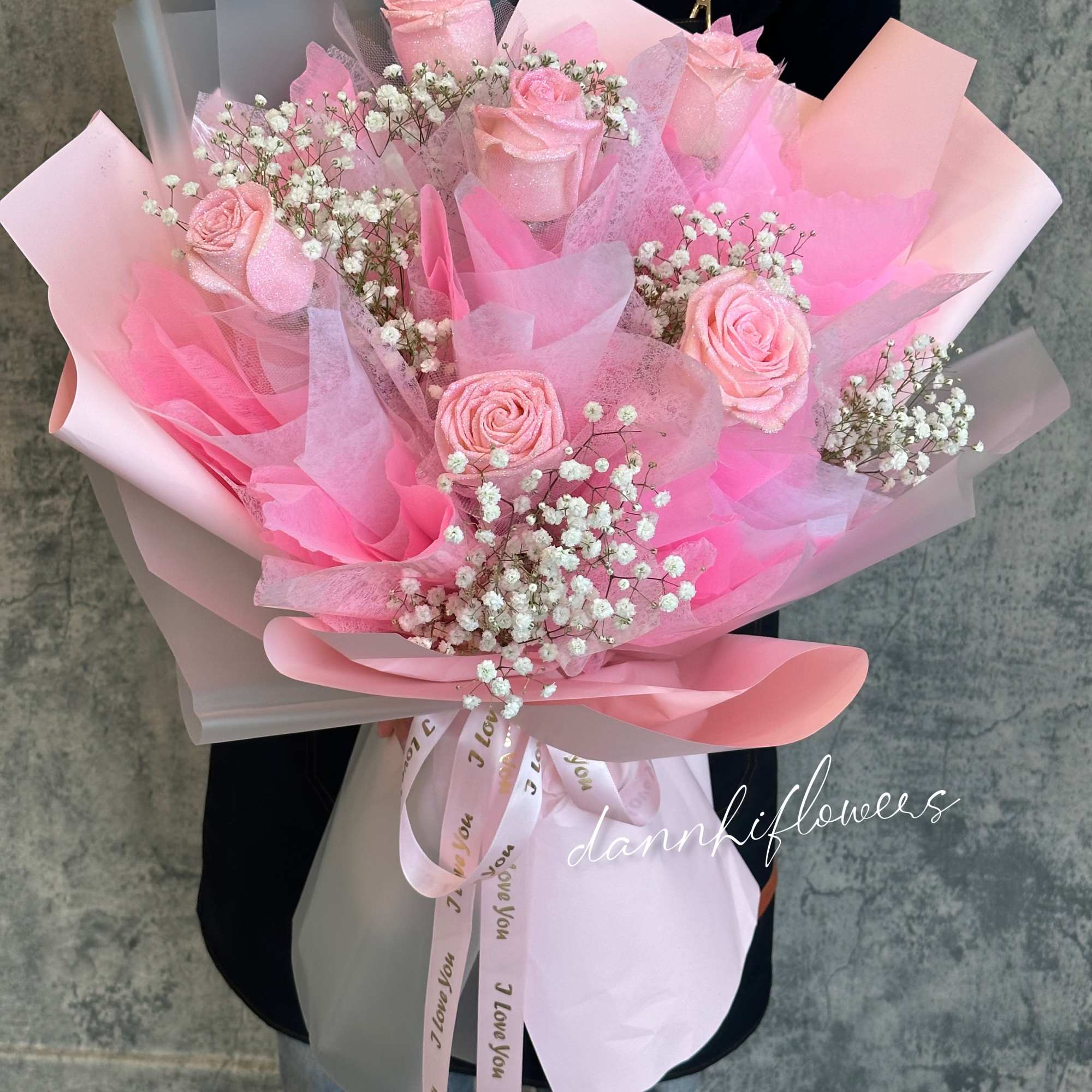 Pink rose bouquet with baby's breath in layered pastel wrapping