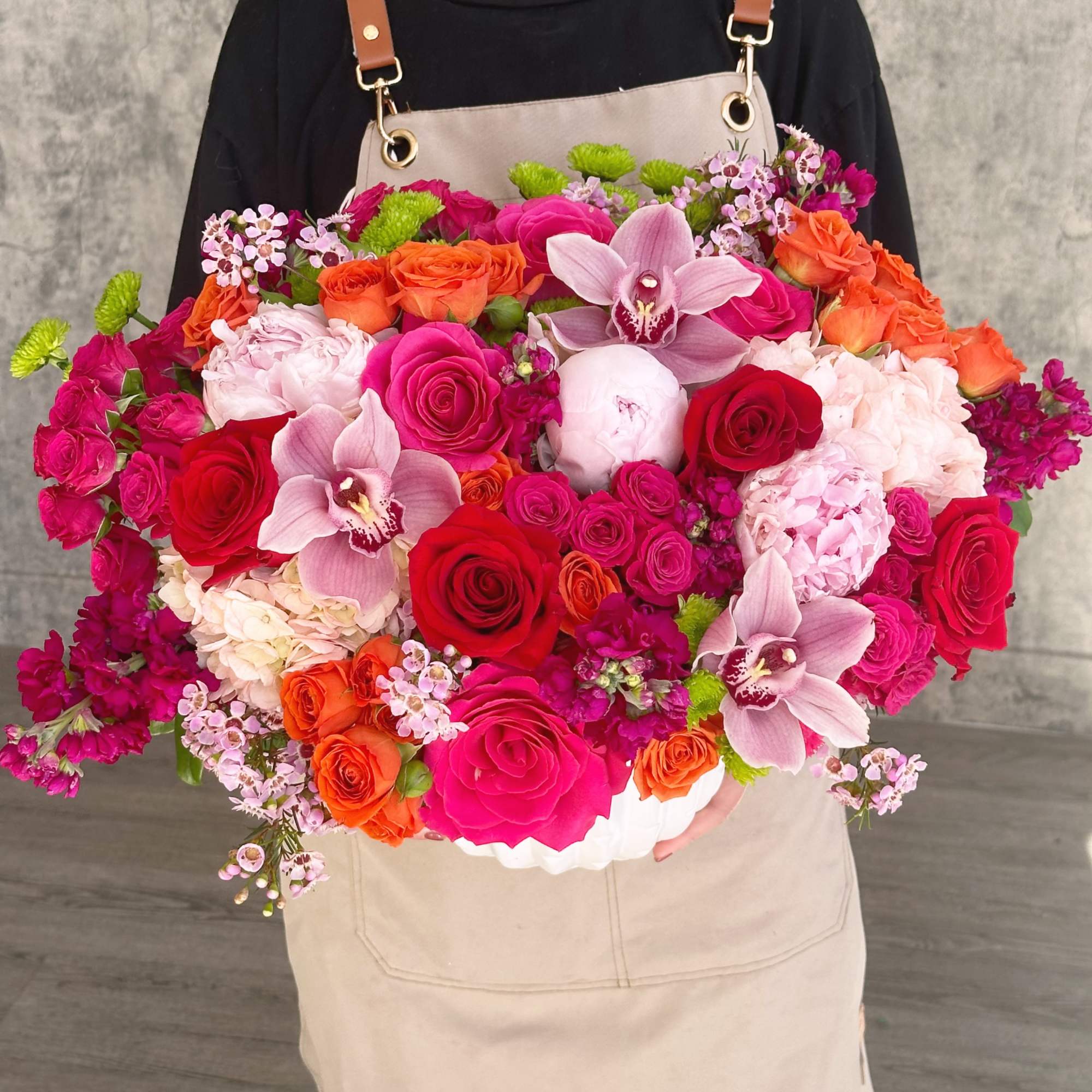 Large mixed bouquet with roses, orchids, and pink hydrangeas