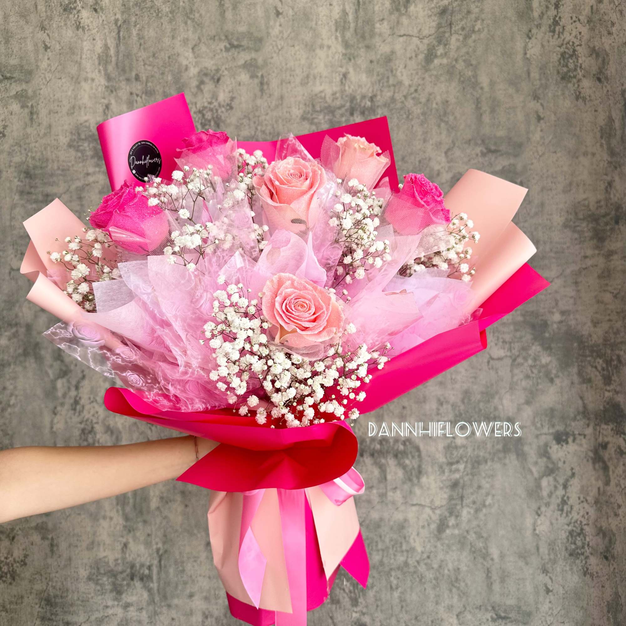 Pink rose bouquet with baby's breath and bright ribbon wrapping