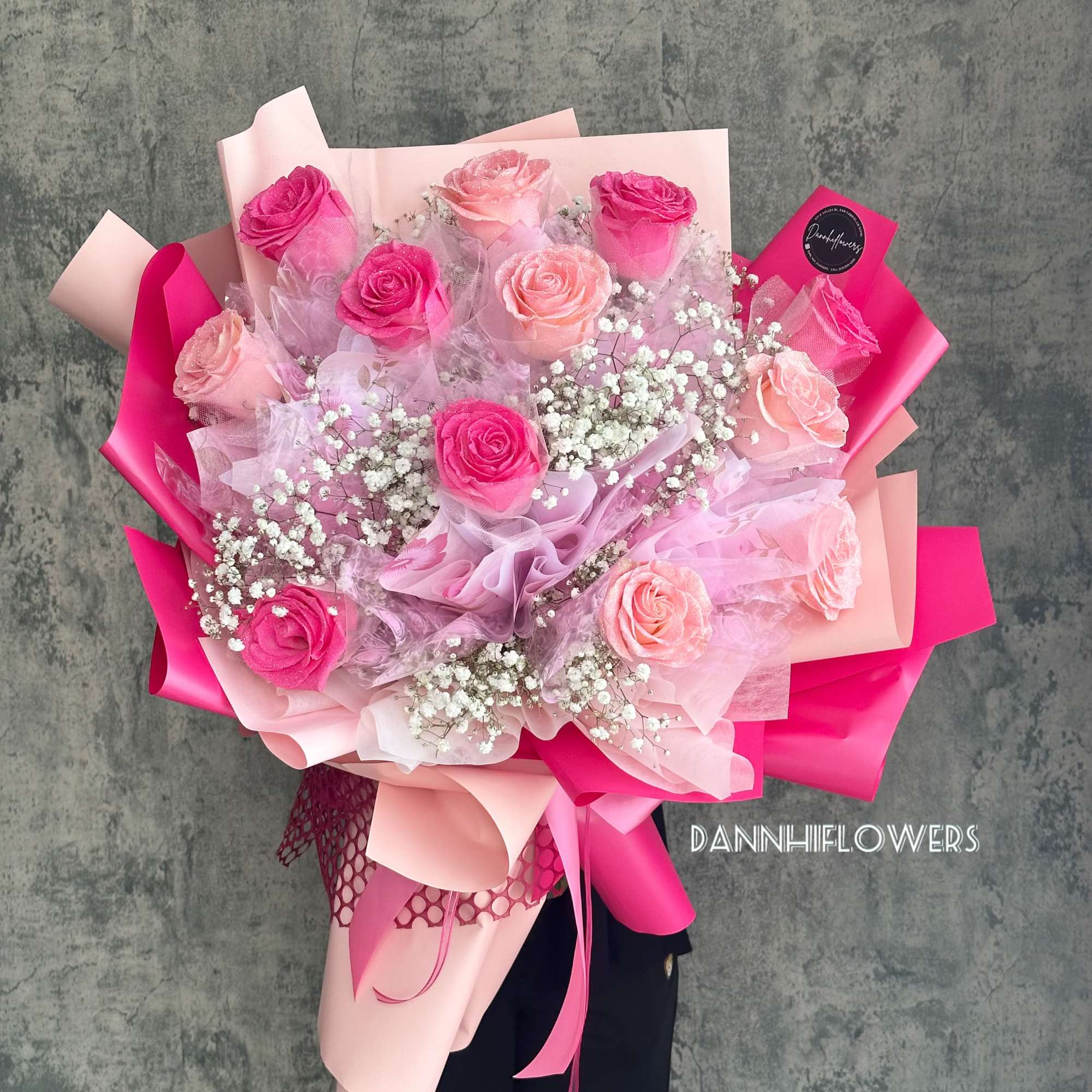 Bouquet of pink and blush roses wrapped in pink paper