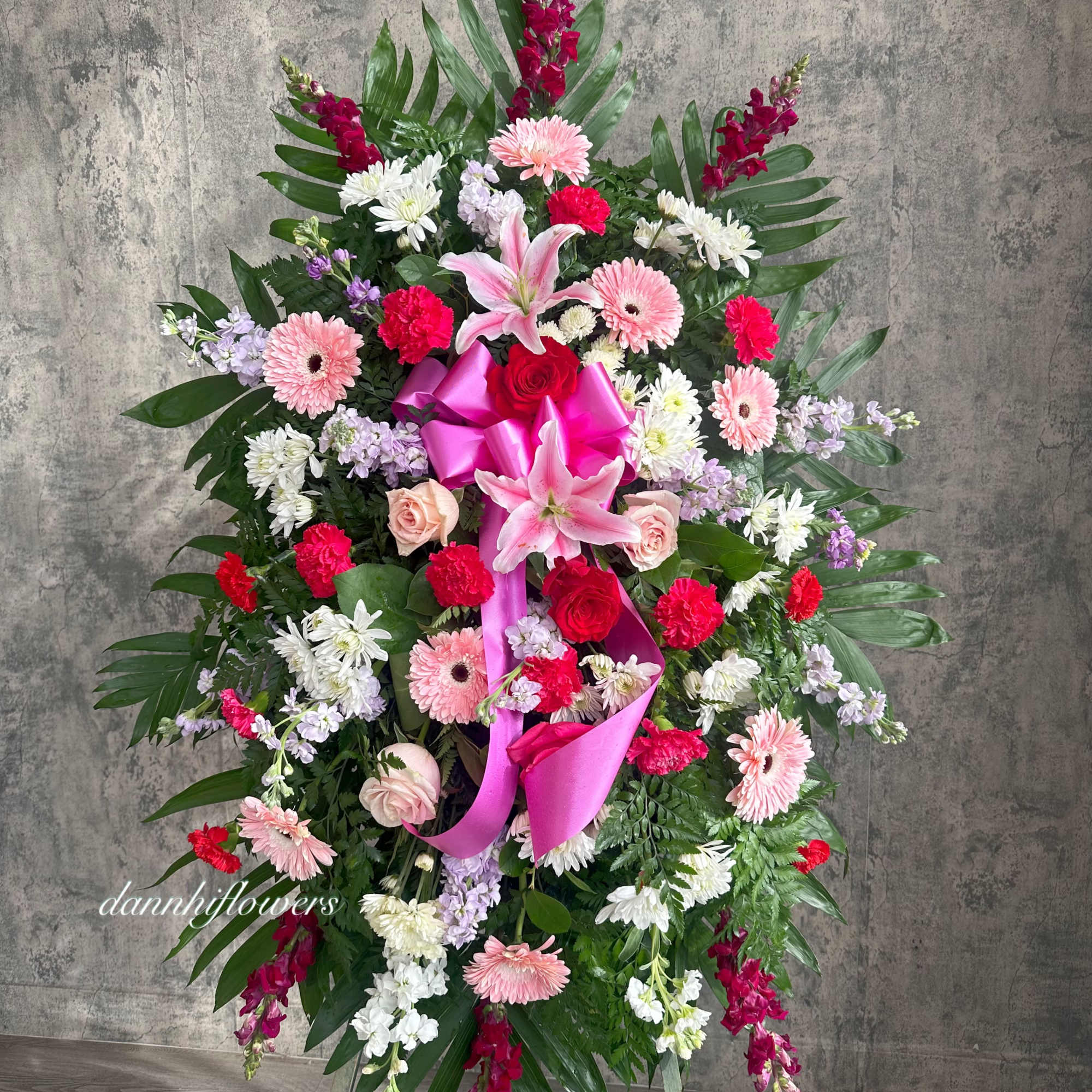 Standing floral spray with pink lilies, roses, and gerbera daisies