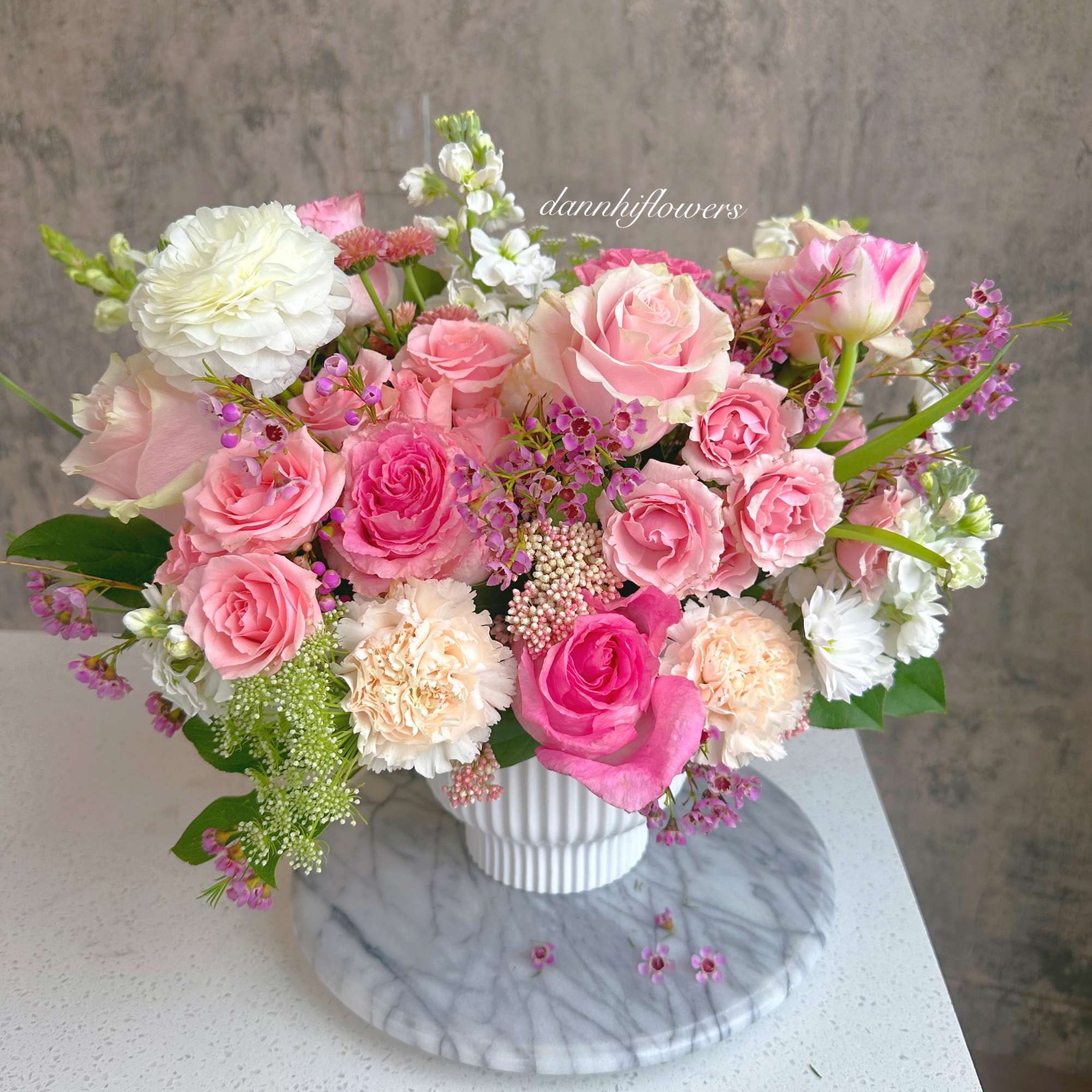 Pink and white rose bouquet in a white vase