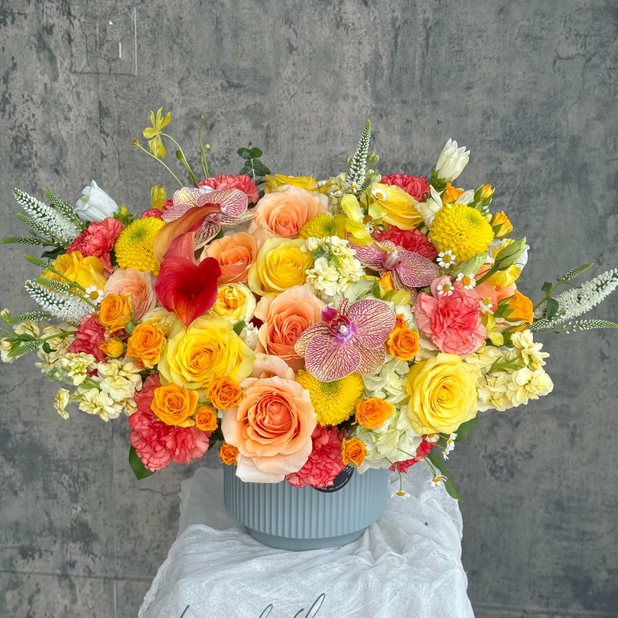 Colorful mixed flower arrangement in a ribbed vase