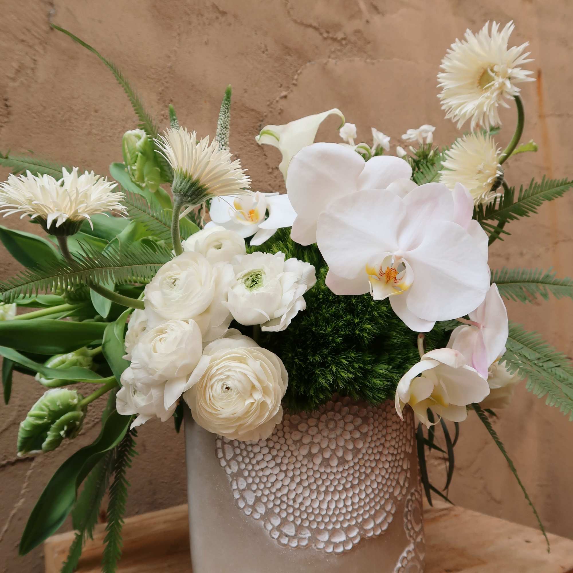 Timeless, features an elegant ceramic vase with a lace trimming design filled
