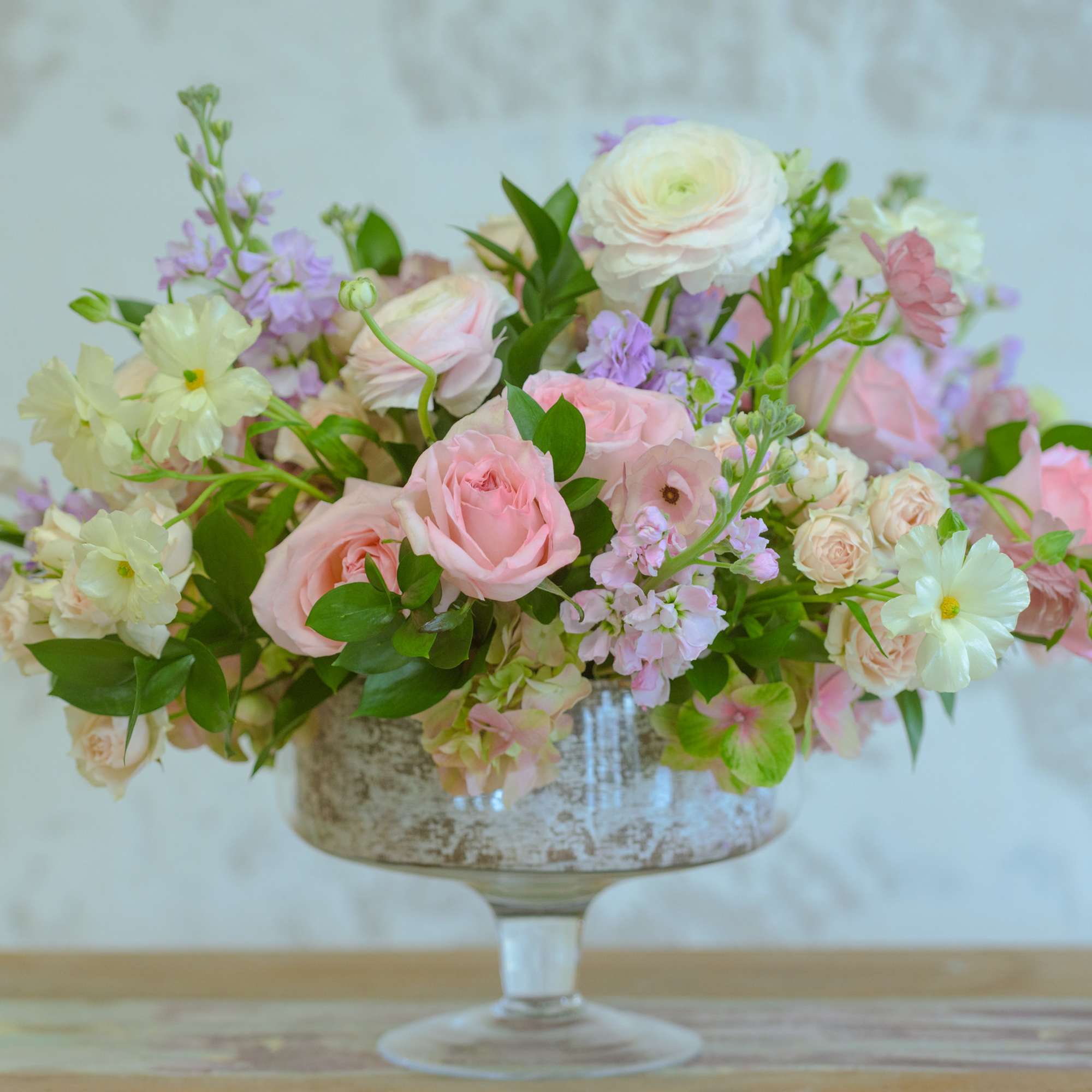 Pink and white floral arrangement in a glass compote vase, photo 2 of 3