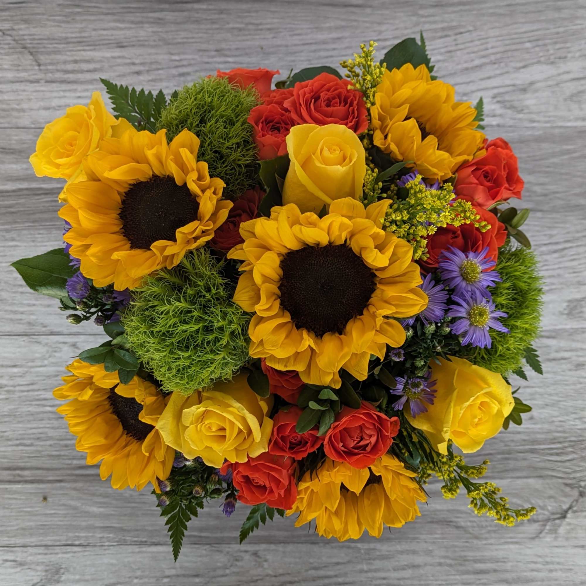 Bouquet of yellow sunflowers and red and yellow roses