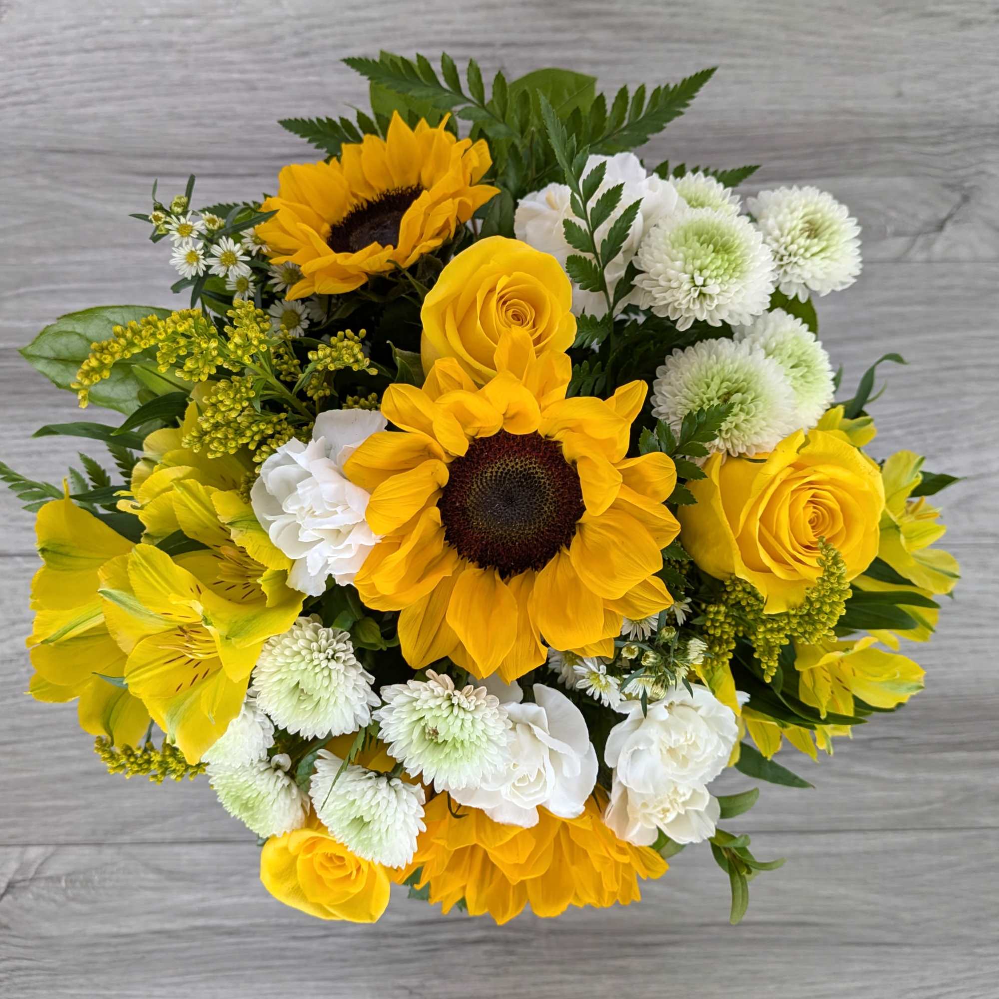 Yellow and white bouquet with sunflowers, roses, and chrysanthemums