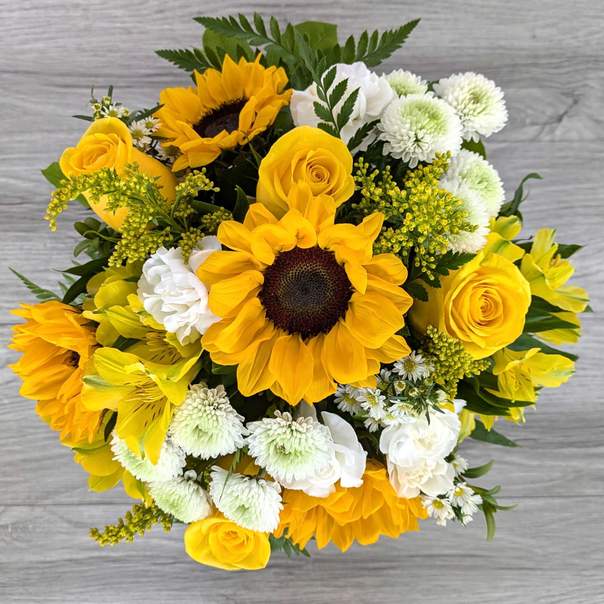 Bouquet of yellow sunflowers, roses, and white mums