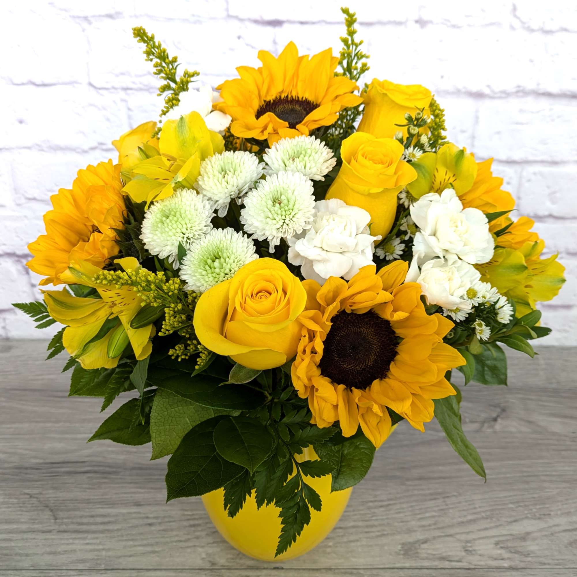 Yellow bouquet with sunflowers, roses, and white mums in a yellow vase