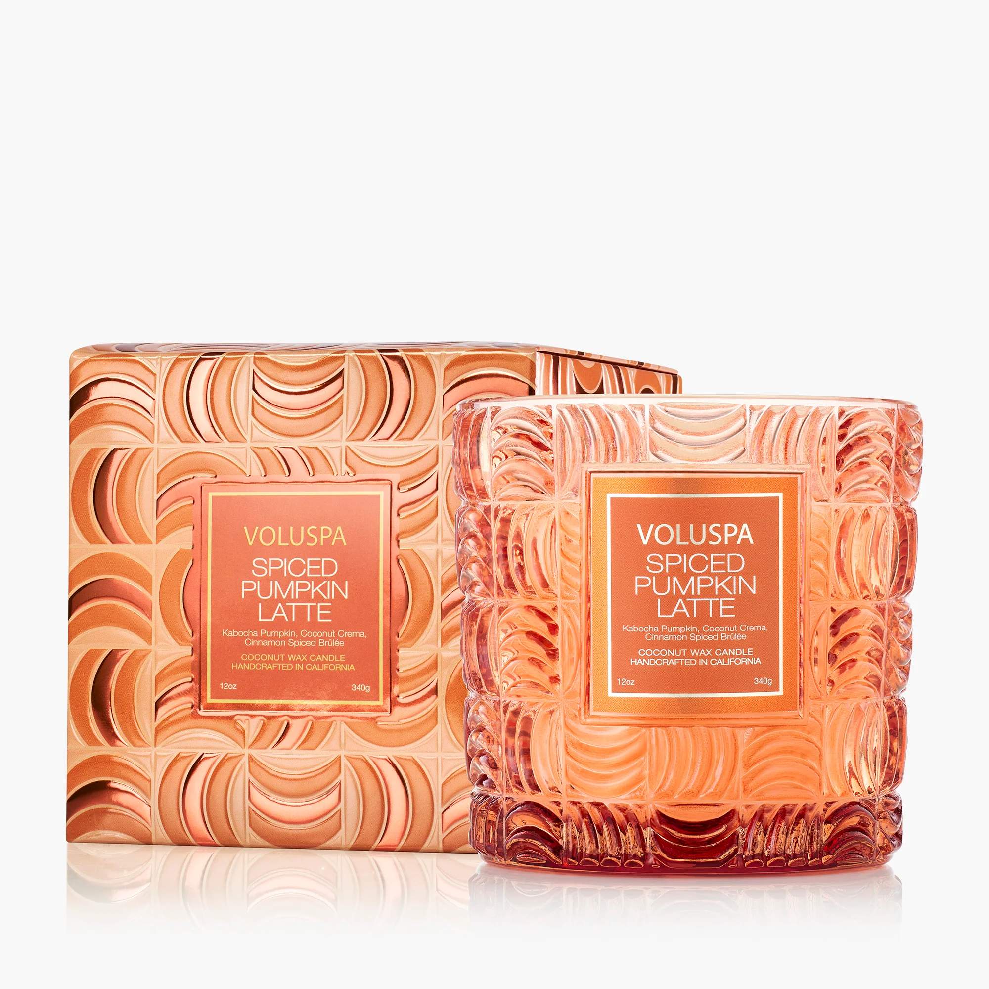Two orange Voluspa Spiced Pumpkin Latte candles in decorative glass jars and box