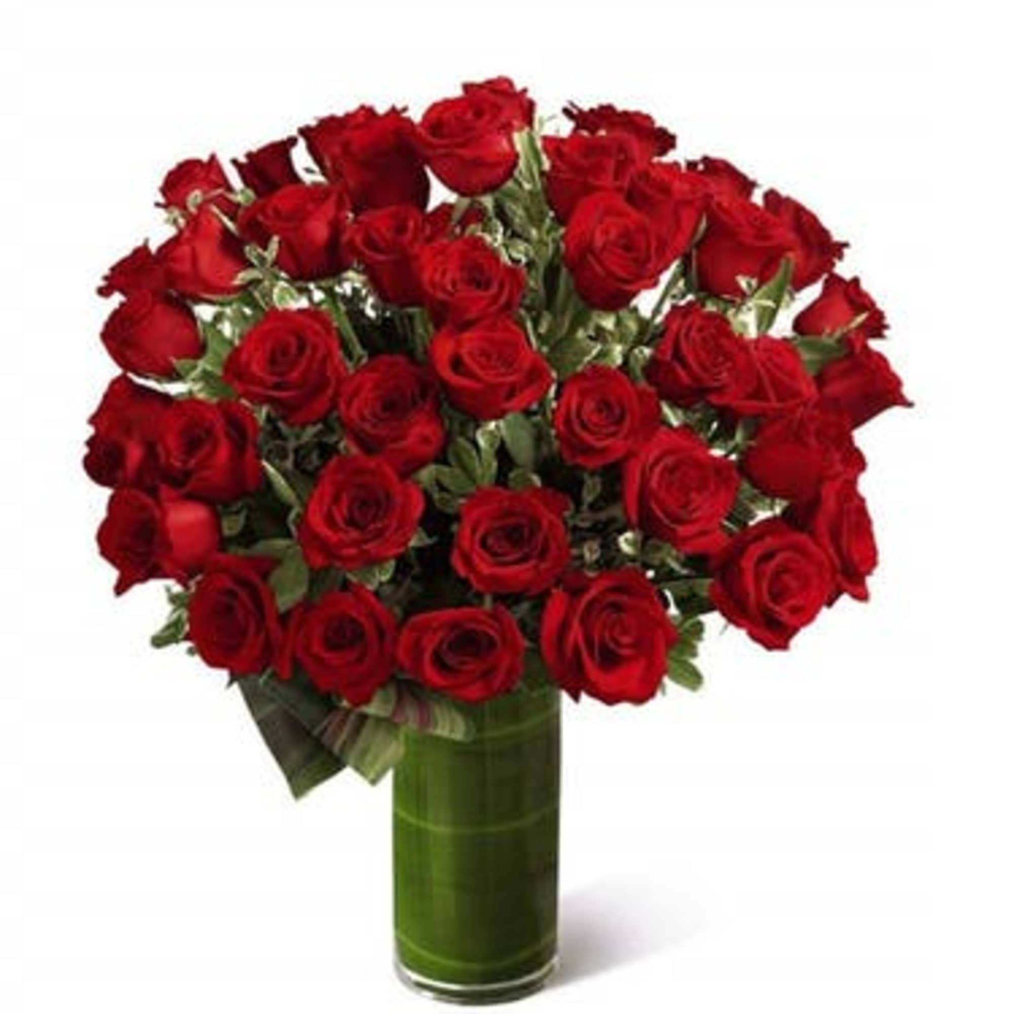 Tall arrangement of red roses in a clear glass vase lined with green leaves.