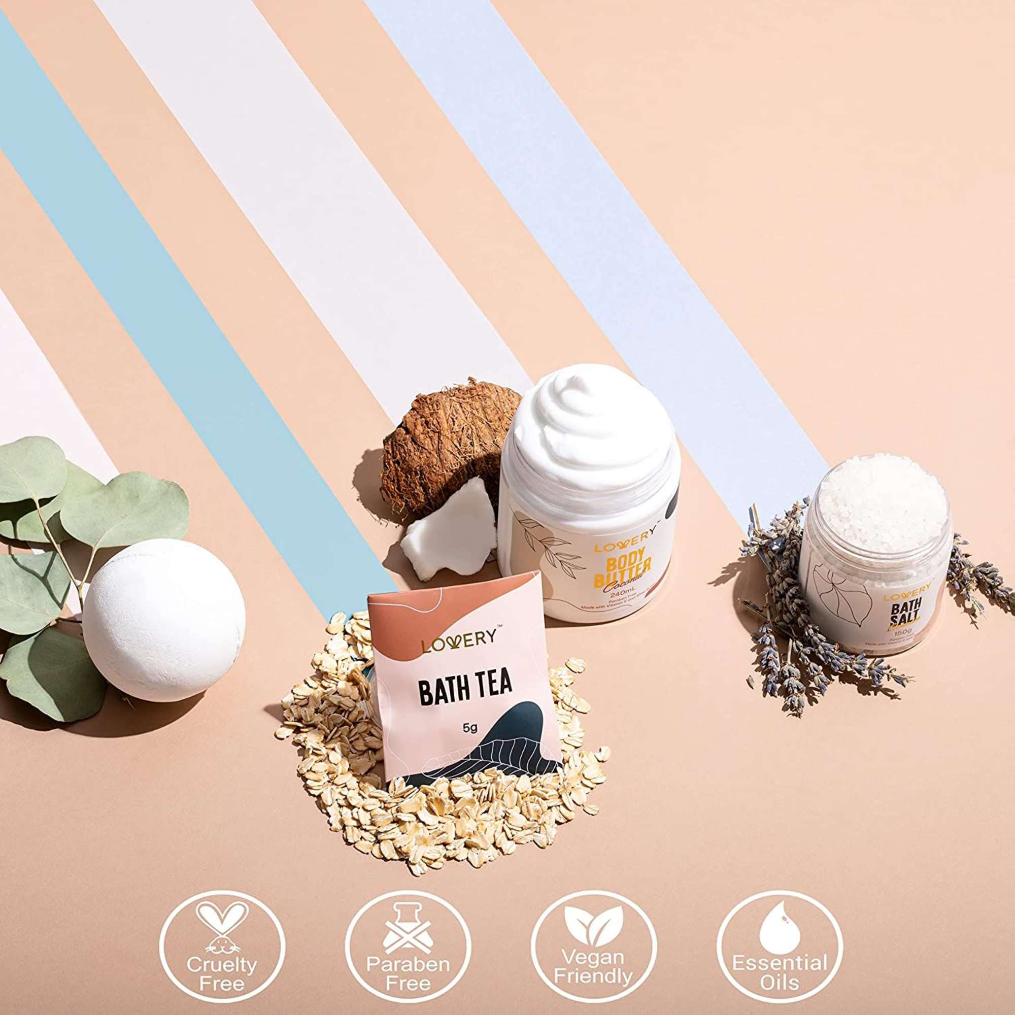 Spa gift set with bath bomb, bath tea, body butter, and bath salts on a pastel striped background