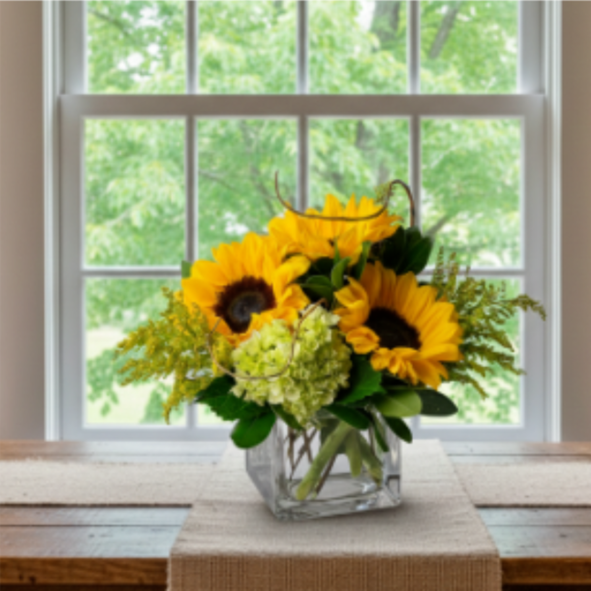 Sunflower bouquet in a clear square vase