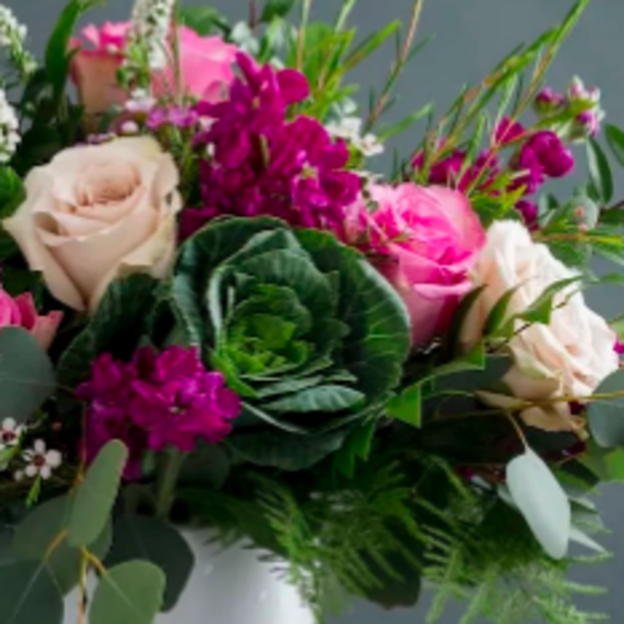 Bouquet of pink and cream roses with purple flowers