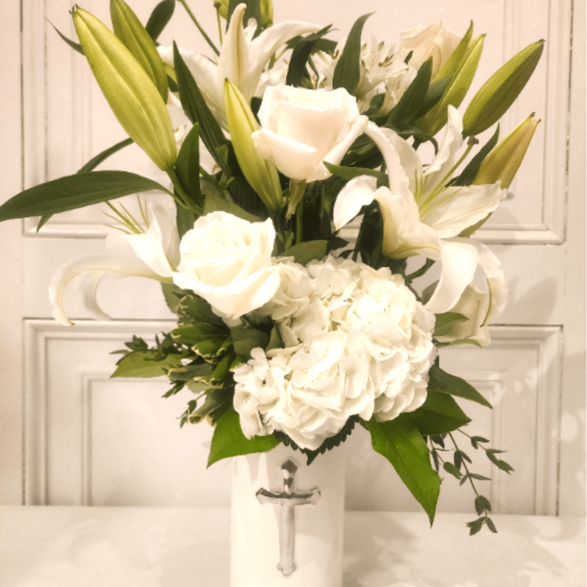 This all-white arrangement of premium flowers is a memorable gesture for any