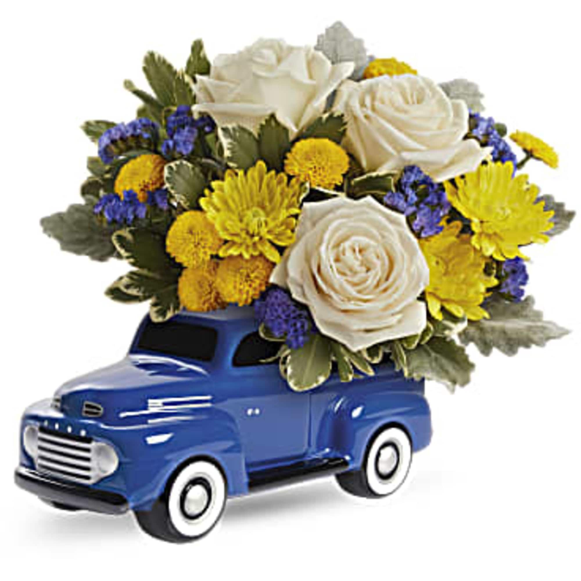Blue toy truck holding white roses and yellow flowers