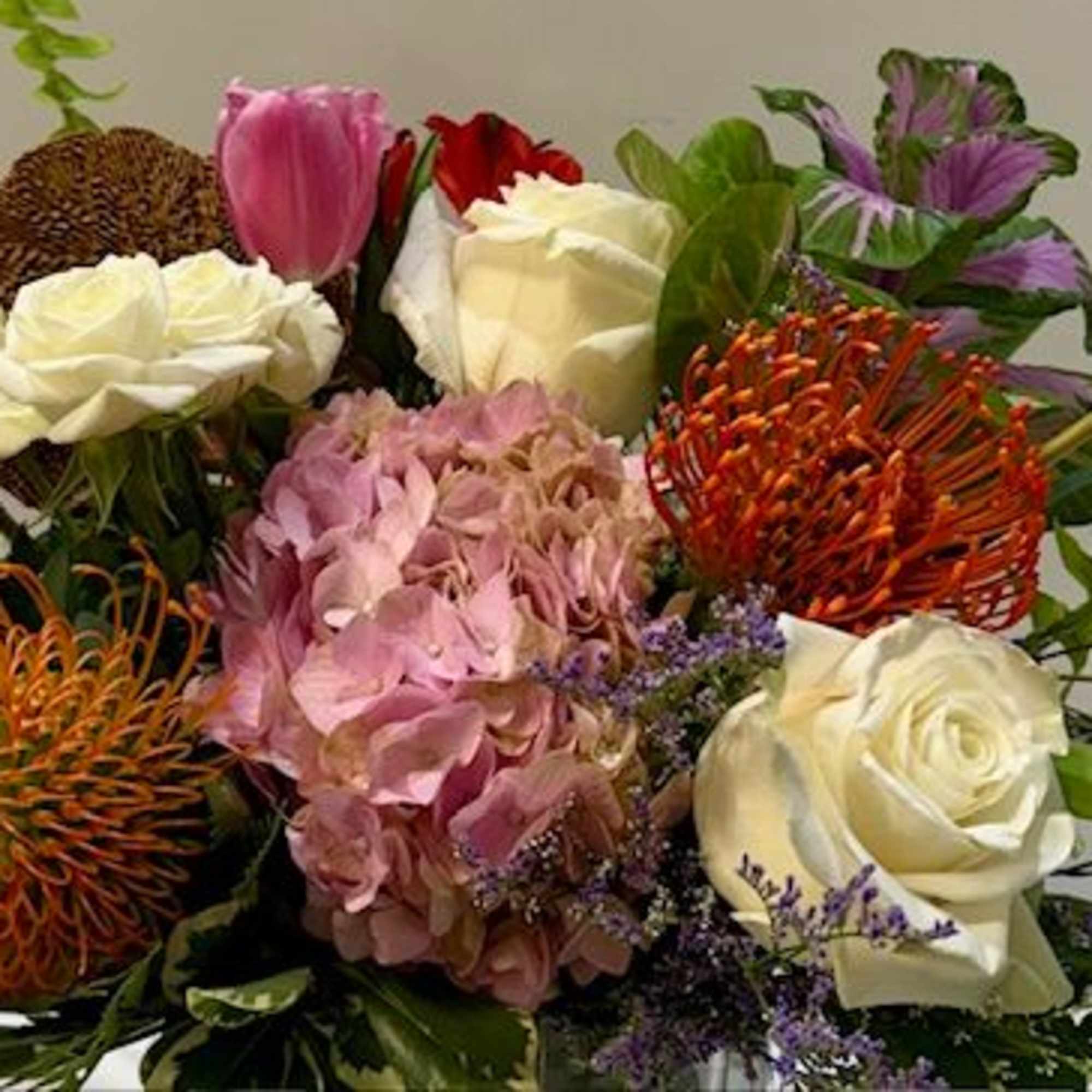 A vibrant arrangement featuring striking pincushions surrounded by soft pink and white, photo 2 of 2