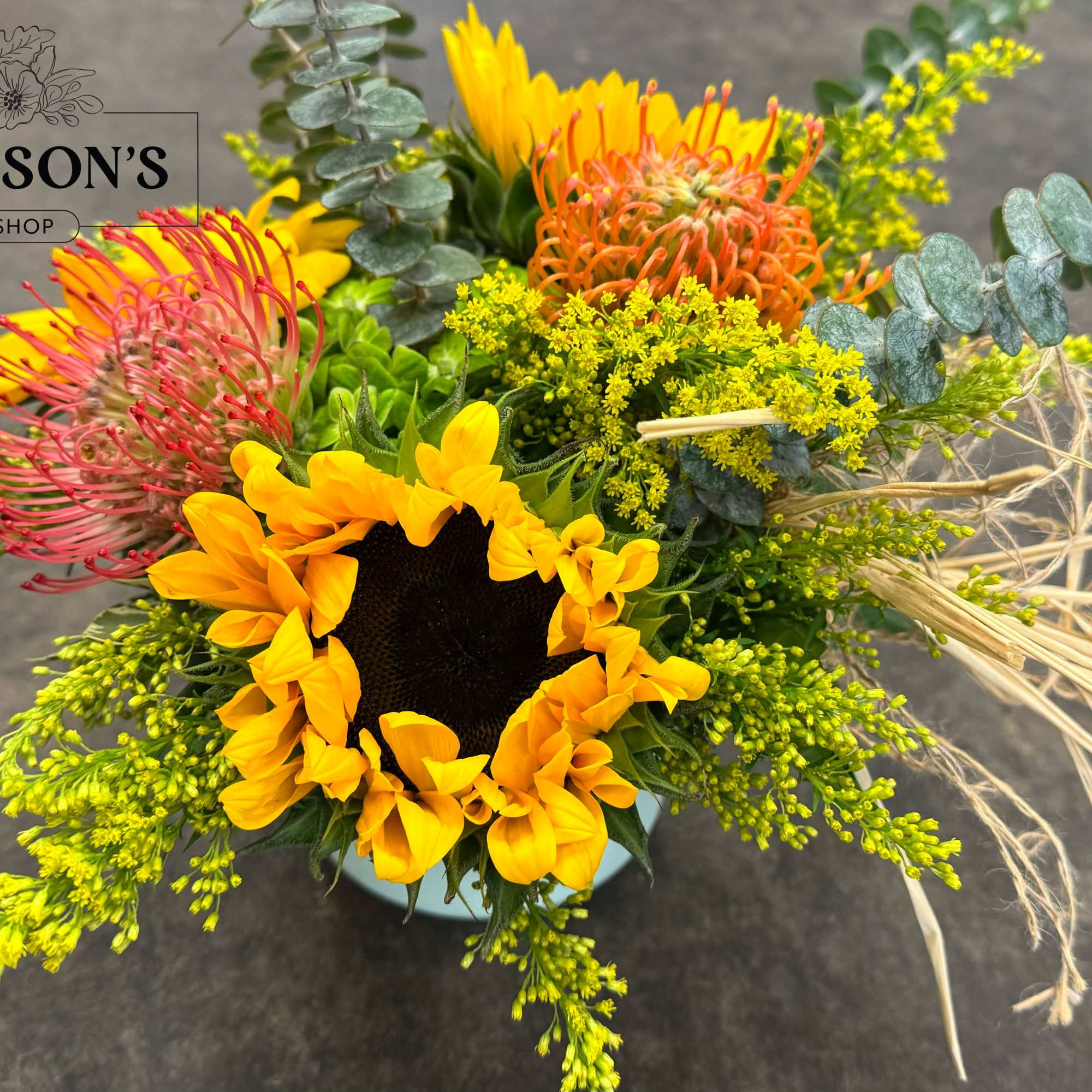 Bright mixed bouquet with a sunflower and pink, orange, and yellow blooms