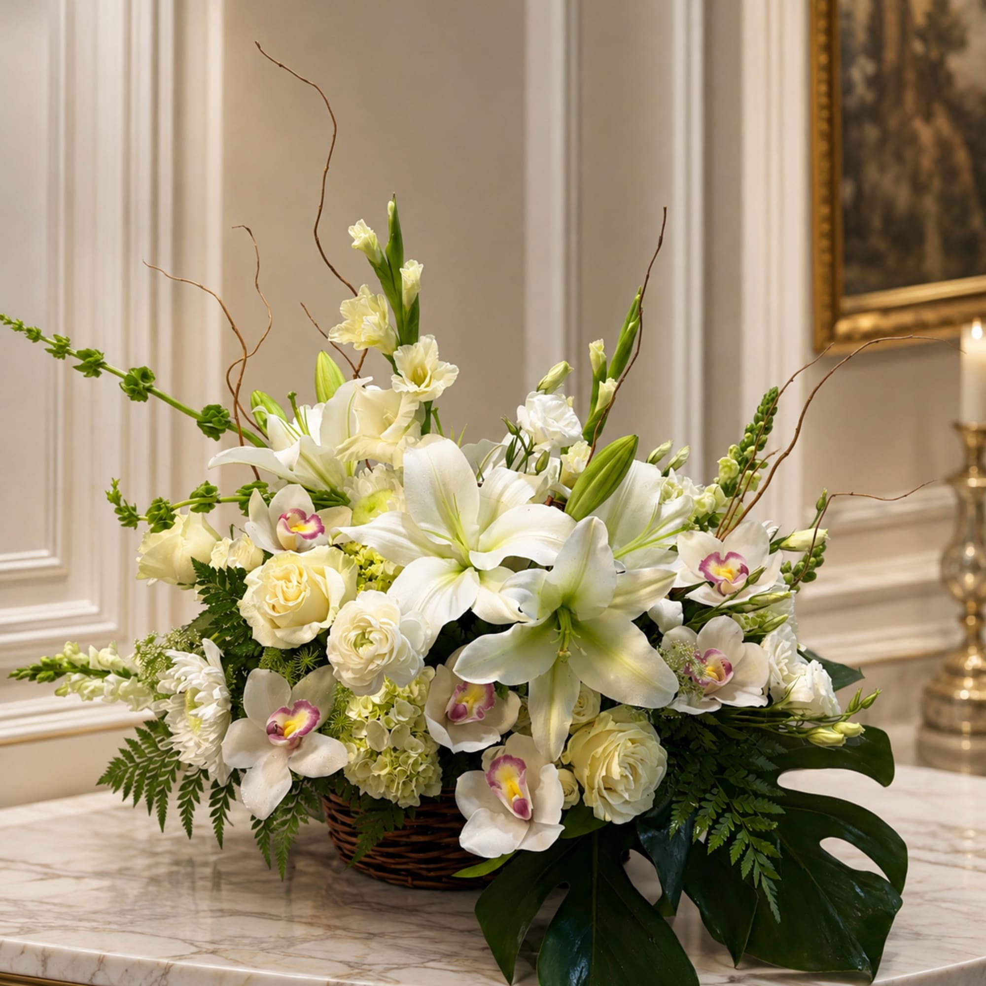 White floral arrangement in a wicker basket with lilies and orchids