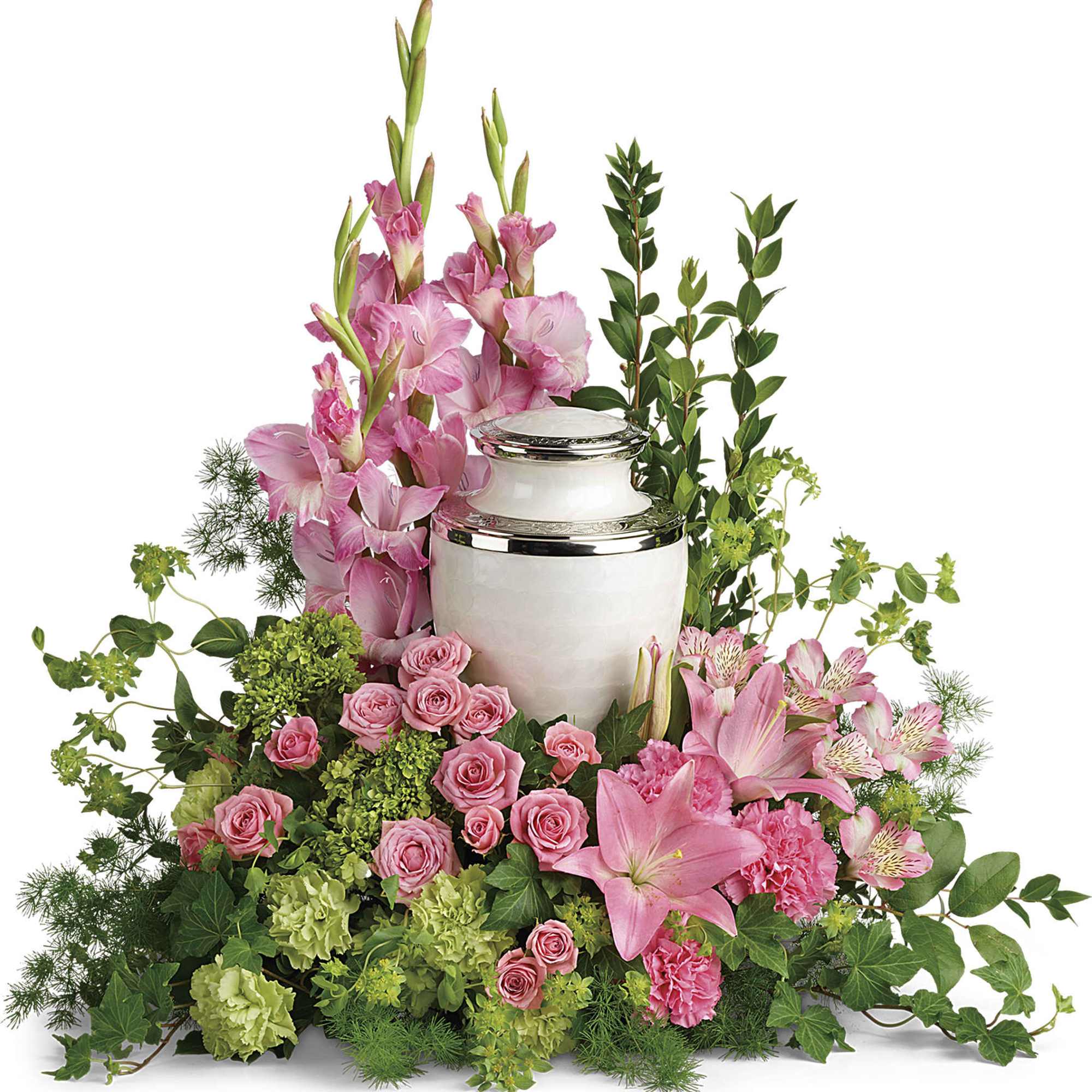 Cremation urn surrounded by pink lilies, roses, carnations, and green hydrangeas in a full floral display