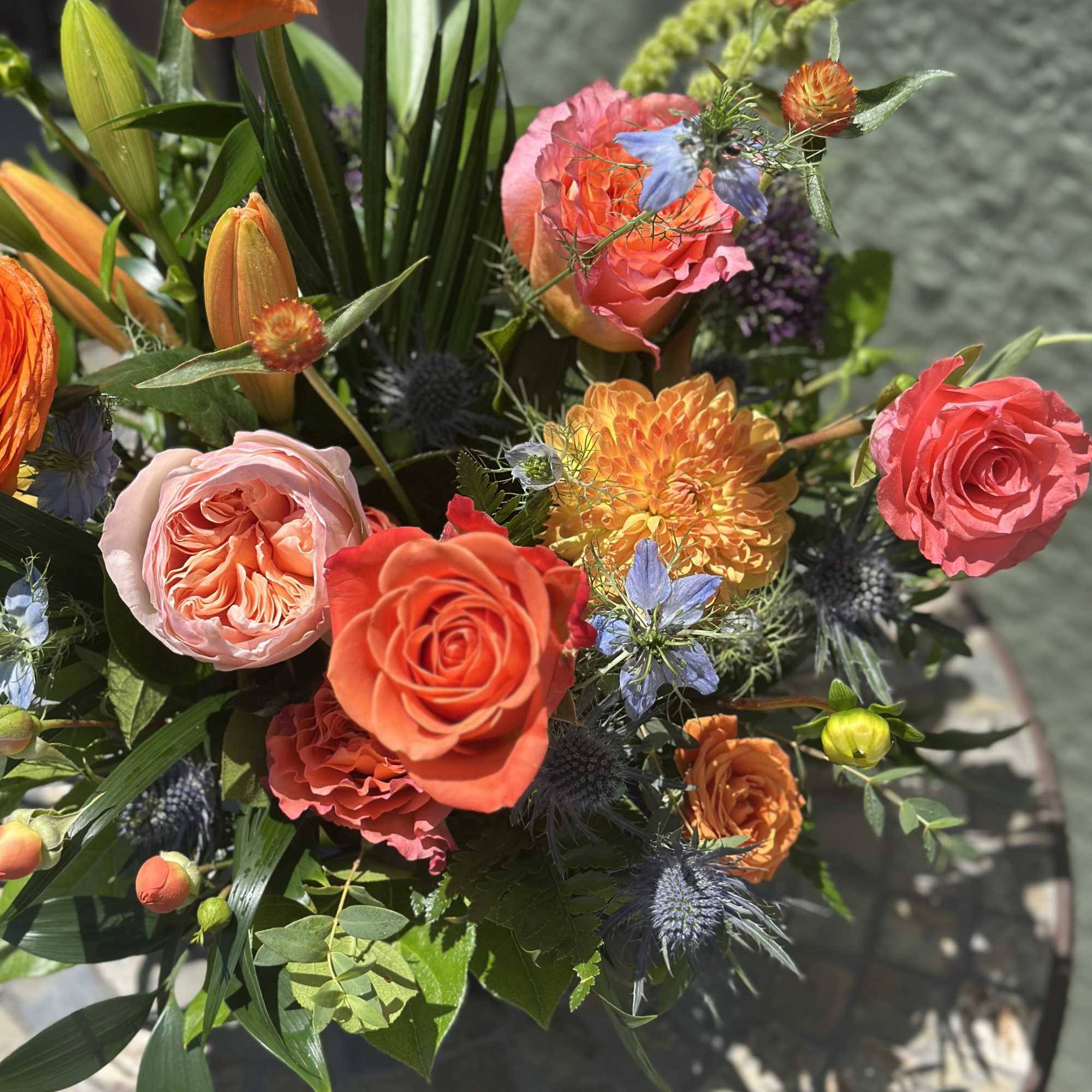 Mixed bouquet with orange and pink roses and orange blooms