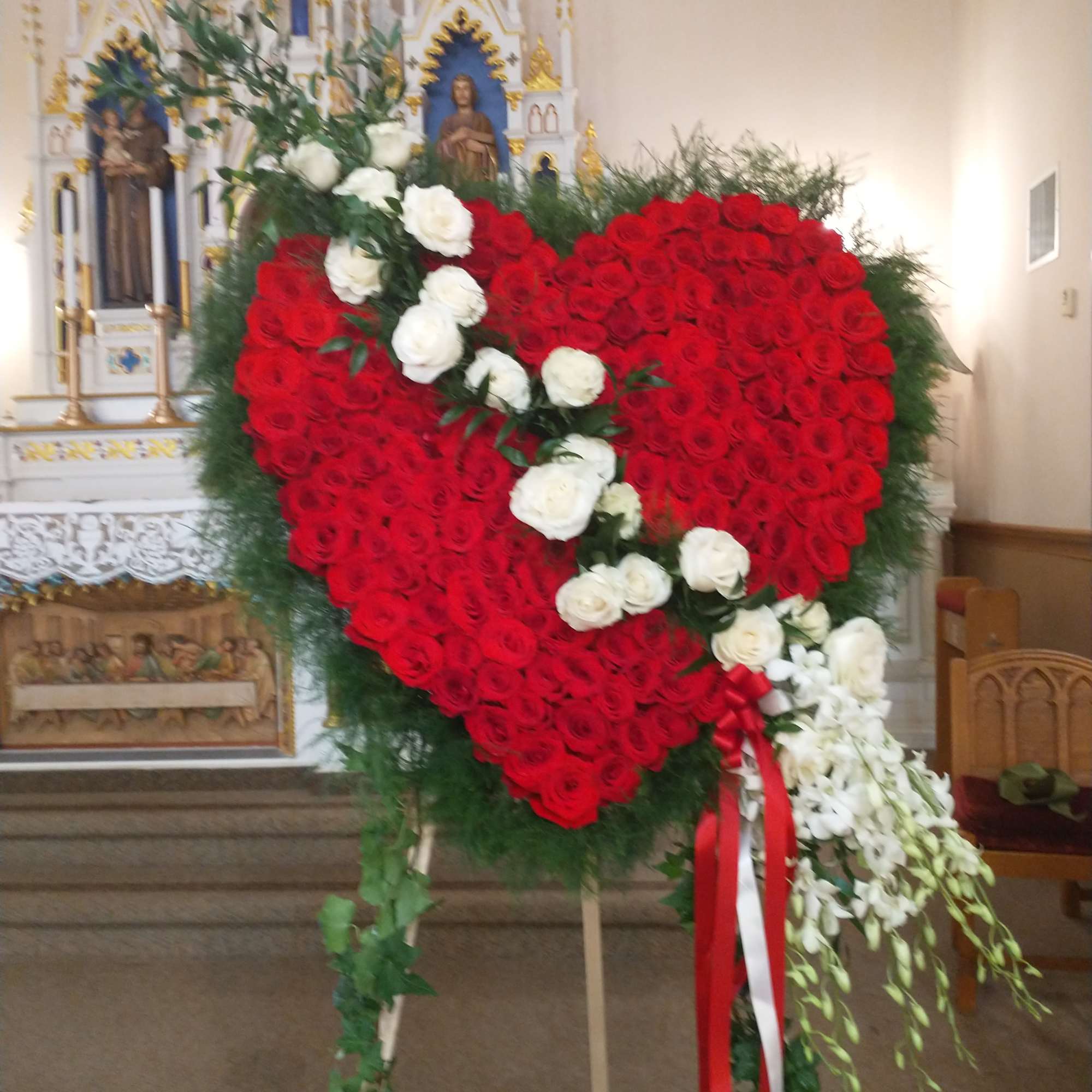 Large heart lovely red roses, white with a cluster of white orchids.